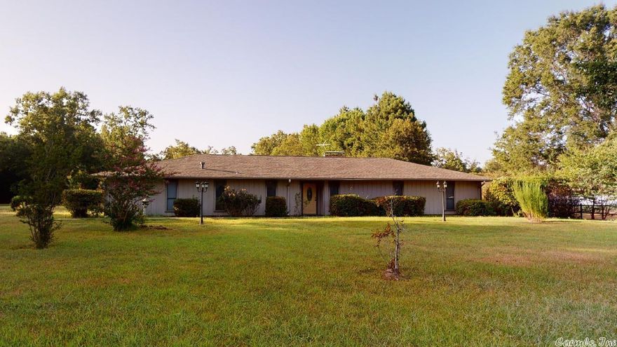 Natural views from this spectacular home! Spacious 4Br/2Ba home is located inside the city limits of Texarkana, AR on 4.79 acres with no restrictions! It has an additional carport for parking or boat/ATV/Golf cart Storage, plus a shop area. Inside the home you will find all the bedrooms are very spacious. Main Living area is exceptionally roomy. Combine this room to have additional dining area for those entertaining evenings with family and friends.This is a home you must see to appreciate all of its charm!