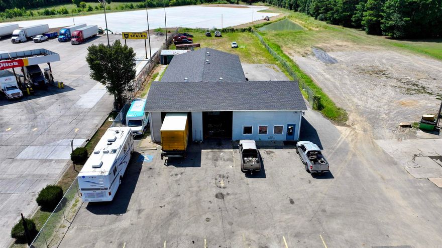 Prime Commercial Opportunity: Established Auto Repair Garage at I-57 Exit 55, Bald Knob, AR This strategically located 4,800 sq ft commercial garage sits directly adjacent to the Pilot Truck Stop at Exit 55 on Interstate 57 (formerly US 67 corridor), offering exceptional visibility and access for travelers. Positioned on the north side of the interstate in Bald Knob, the property serves as an ideal stop for motorists heading toward Batesville and beyond, in one of Arkansas's key transportation corridors connecting North Central Arkansas, Missouri, and Tennessee. The building features three service bays, including a spacious rear bay specifically equipped and utilized for semi-truck repair and service—perfectly suited to capture demand from over-the-road truck drivers frequenting the neighboring Pilot Travel Center. Additional amenities include a compact office area, two restrooms, and prominent roadside signage for maximum exposure. Spanning 1.14 acres, the property provides ample space for operations, parking, or future expansion. Its prime interstate adjacency positions it to benefit from ongoing regional infrastructure improvements and economic momentum along the I-57 route.