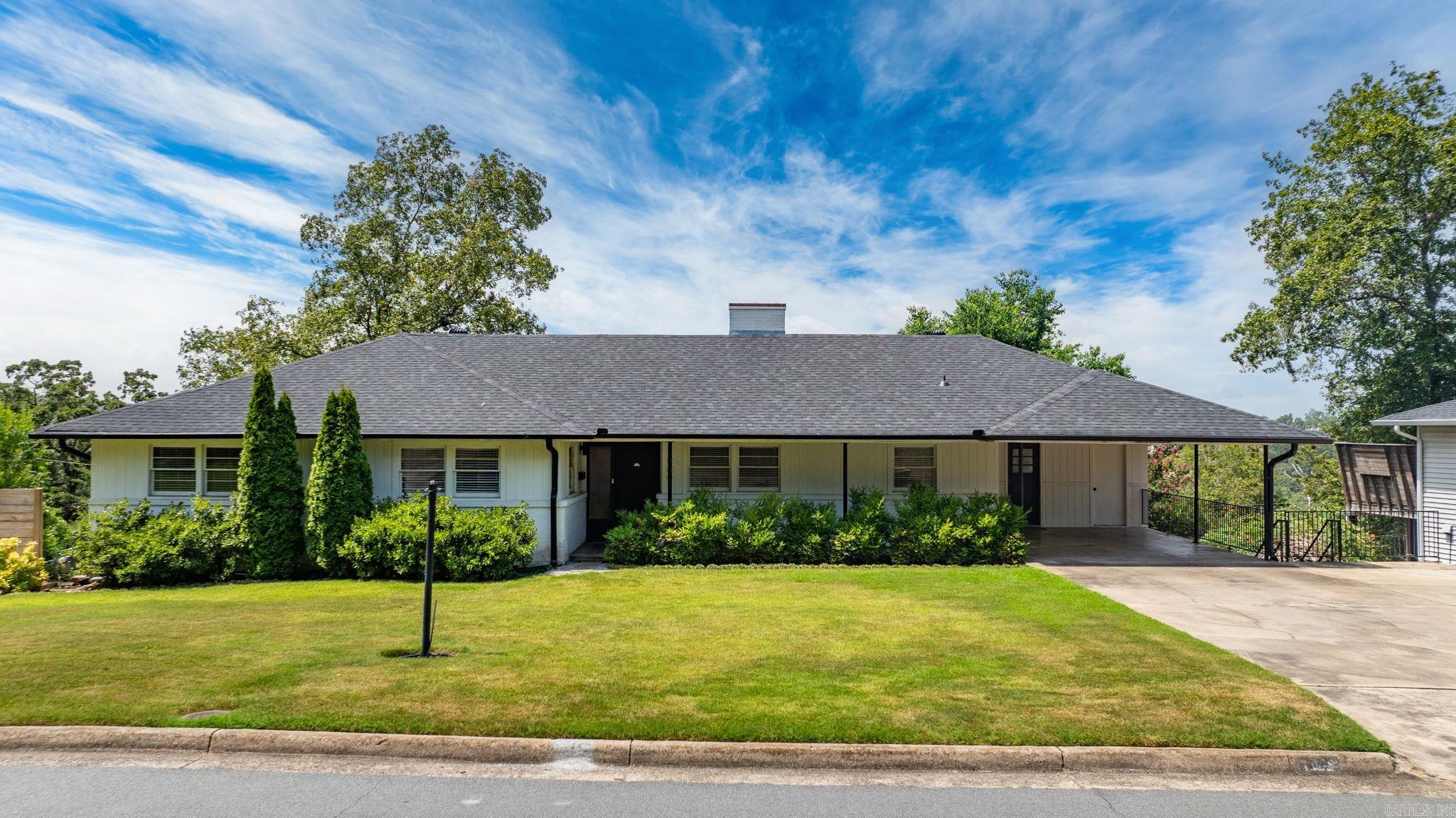 Charming and extensively renovated home on a coveted street. This ranch-style split to the rear has 4 spacious bedrooms, 3 stylish bathrooms, and two versatile living spaces. On the main floor, you'll enjoy a beautifully updated kitchen, gas log fireplace and gorgeous vista views. The primary and two additional bedrooms are on the entry level. Downstairs, you'll find the second living space with woodburning fireplace, an additional bedroom, laundry and unfinished basement (currently used as a home gym). Step outside to enjoy a two-story deck overlooking the private yard. New HVAC in 2025, and new roof in 2023. The home is the perfect blend of character, function, and location! Additional storage space attached to the house and accessible from outside not pictured.