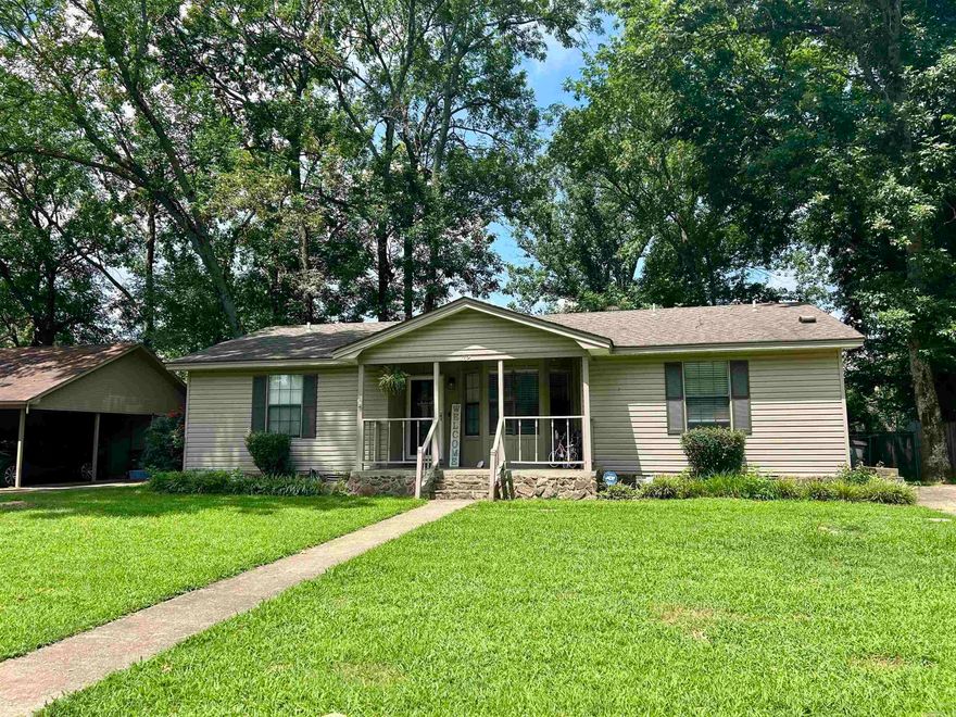 Cute 3-Bedroom Home in a popular Neighborhood.  This inviting 3-bedroom, 2-bathroom home offers a functional split floor plan and is located in a desirable neighborhood. The kitchen features tile flooring, painted cabinets, a pantry, and a convenient laundry closet. The open-concept living and dining area is accented by a beautiful ceiling beams, creating a natural division between spaces and Rustic charm. A rock, wood-burning fireplace adds warmth and character to the living room, which also includes an extra closet for versatile storage. Double doors lead to a charming fenced backyard, perfect for relaxing or entertaining.  Additional outdoor features include a portable storage building and a covered storage room under the roof-line. The primary bedroom includes a private full bathroom. Two bedrooms are carpeted and in good condition. While the flooring in both bathrooms and the LVP needs replacement, the home is priced accordingly, offering great potential for personalization.  Major updates include a roof just 8 years old and a new HVAC system installed 5 years ago.