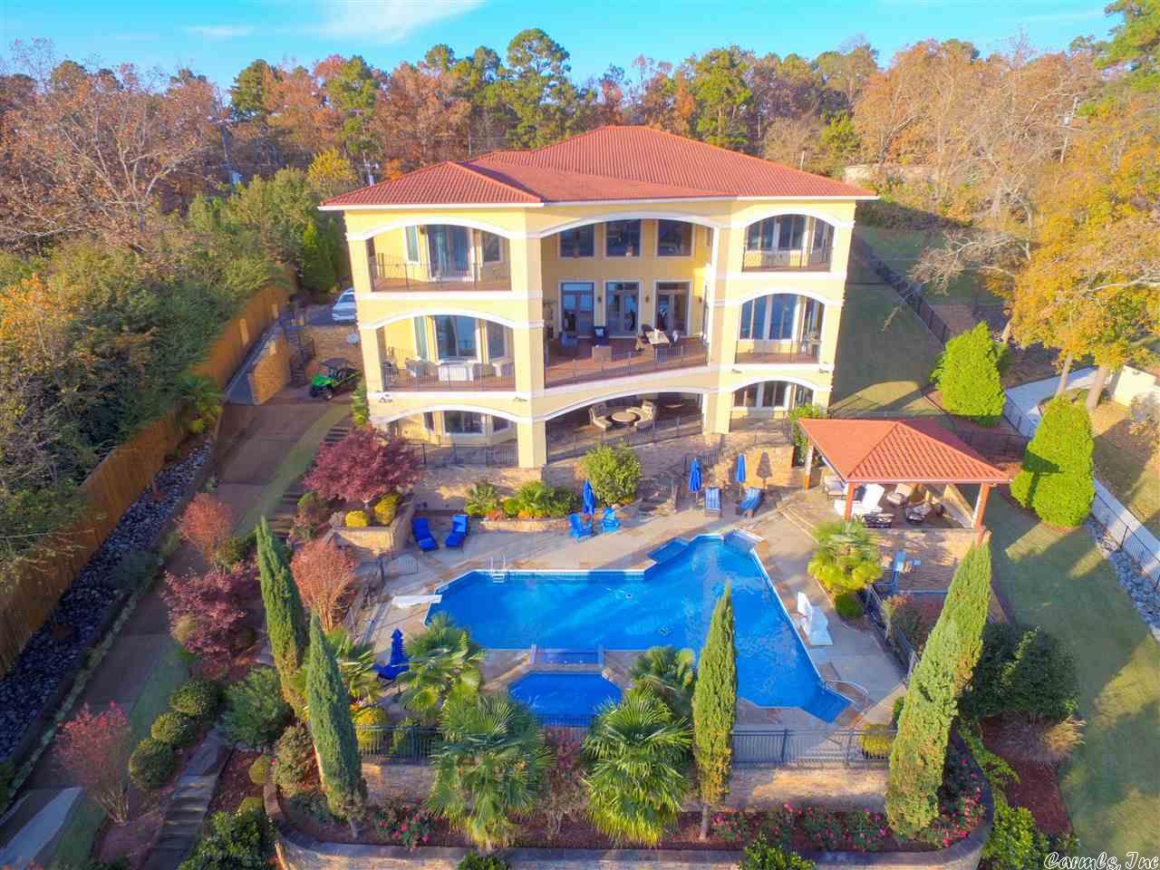 THIS SMART HOME IS THE ULTIMATE IN QUALITY (CONTROLLED BY IPAD), SUPERBLY DESIGNED, WITH FLOWING ARCHED WALKWAYS & SURPRISING SPLASHES OF WORMWOOD WITH HIGH CEILING SPLENDOR. THIS 12,500 SQ FT 5 BEDROOM- 6 FULL BATH- 2 HALF BATH MEDITERRANEAN LAKE HAMILTON HOME HAS PRICELESS VIEWS & ROOM TO S-P-R-E-A-D- OUT. ** VRBO READY ** WHEN ENTERING, NOTICE THE ATTENTION TO DETAIL FOR LAKE VIEWS. FORMAL DINING ROOM, 2 FULL KITCHENS WITH GOURMET APPLIANCES, BREAKFAST NOOKS, CLIMATE-CONTROLLED WINE CELLAR, WALL TO WALL COMFORT--> THIS HOME HAS FOAM INSULATION, 4 GEOTHERMAL HEAT & AIR SYSTEMS (LAKE), 3 TANKLESS HOT WATER HEATERS W/CIRCULATING PUMP, SHAW HARDWOOD FLOORS, WORMWOOD CEILINGS & TRIM, 3 CHANDELIER WINCHES, ALL GRANITE COUNTERTOPS, 2 LAUNDRIES, HEAT & COOLED TRAVERTINE FLOORS DOWNSTAIRS, AUTO STANDBY GENERATOR, OVER 2000 SQ FT OF DECKING (TREK), FULL IRRIGATION SYSTEM, OUTSIDE CABANA W/ KITCHEN & FIRE PIT, HEATED SALT WATER POOL & HOT TUB W/ FLOWING WATERFALL, SAND BEACH W/ TIKI HUT, 2 STALL BOAT DOCKS W/ LIFTS, SWIM DOCK-2-JET SKI RAMPS>