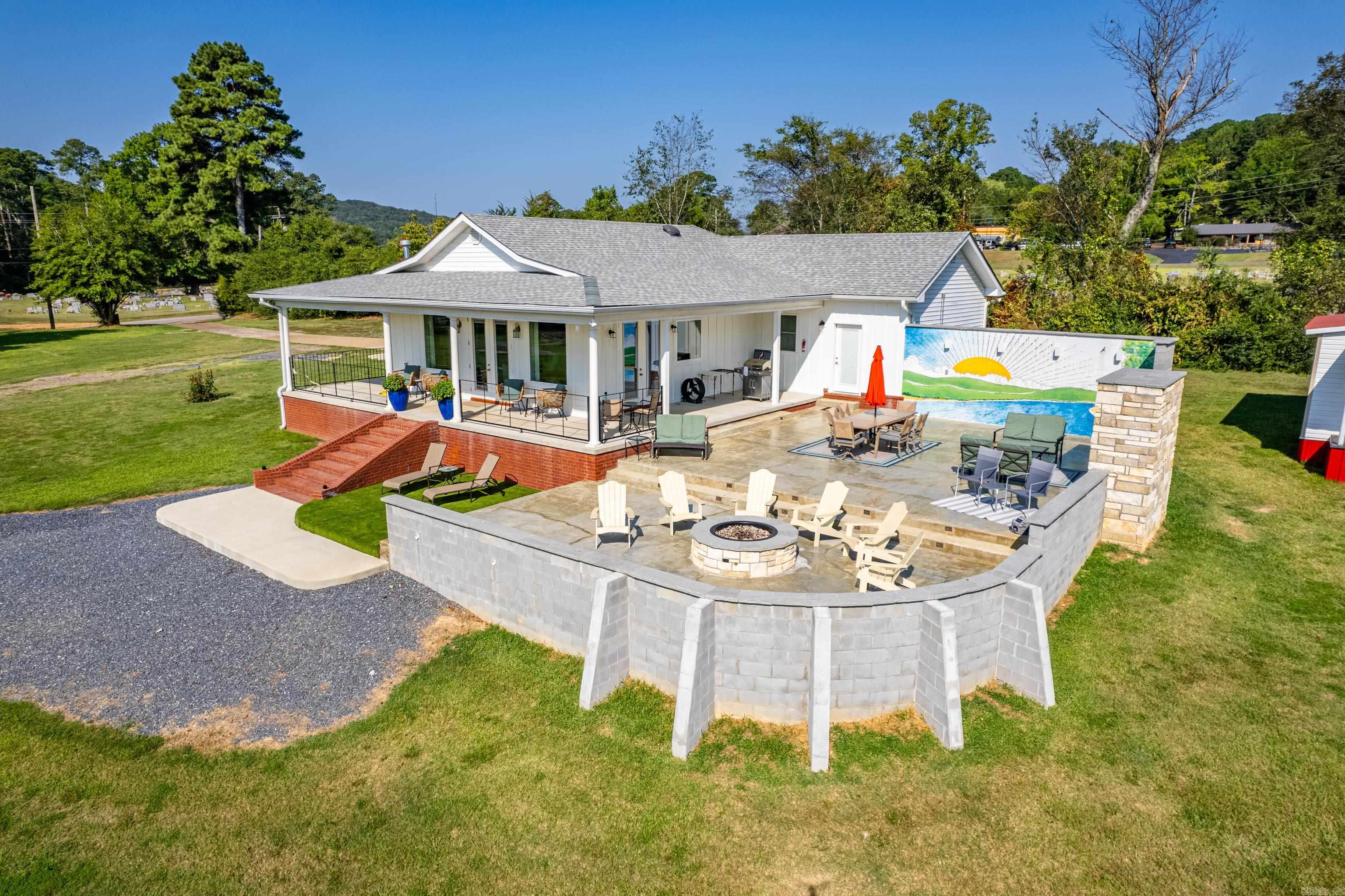 Welcome to Crawford's Lookout, a beautifully updated, single-level home on a serene 3-acre parcel stationed on the banks of the Caddo River. Conveniently located on the West end of Glenwood, AR, and with direct river frontage, Crawford's Lookout is your gateway to the outdoorsāfish, swim, or launch canoes from your backyard. Adjacent to a storybook park, it is perfect for family photos and picturesque moments...think...Family Reunions, Engagements, Weddings! Step inside to discover an inviting, open-concept floorplan ideal for relaxation & hosting. The well-appointed interior accommodates sleeping and interior dining for 12, not to be outshined by its abundant outdoor entertaining space, making Crawford's Lookout ideal for groups and gatherings. Crawford's Lookout is offered turnkey with everything you need for immediate enjoyment of your river front investment. Watch the eagles soar, enjoy the sunrise over the river, or roast marshmallows by the fire. An ideal lay of the land affords an easy walk to the water and did not require the home to be built on stilts or carry flood insurance, providing peace of mind along with its riverfront charm. Experience the tranquility & adventure.