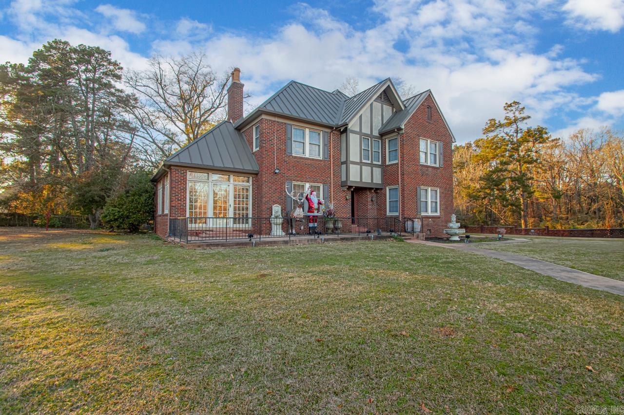 Exquisite two-story Tudor home with a rare blend of timeless charm and updated conveniences. Featuring 3 bedrooms, 3 baths, formal dining and spacious living room, a cozy den, and 2 offices/ sunroom. This historic home has Anderson windows, an updated kitchen, gas fireplace & original hardwood floors that exude warmth and character. The high ceilings and intricate trim details further enhance the old-world charm of this remarkable property.. It also includes a 2 car garage, basement, and separate mother-in-law quarters/guest house, all set on 6 acres. This property has endless possibilities! This is your opportunity to own a piece of history, complemented by elegant architectural details and the serenity of expansive acreage. The guest house is 780 sq ft 1 bedroom 1 bath. New metal standing seam roof 2019