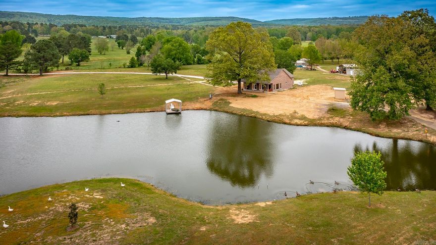 Beautiful Property w/Brick Home that Seller has worked hard setting up for his wife to fulfill her dream of moving to Arkansas,but unfortunately she has passed so Seller would like to move back to Texas.The home is not fully finished,but someone can complete & make their own.The 24x24 garage is fully insulated if someone wanted to make a 2nd bedroom.The Primary bedroom overlooks the pond which has a 12x12 floating covered dock w/electric & the pond has a pretty waterfall that lights up at night. The 12.31 acres also includes a 10x20 tiny house (unfinished but could be finished out to make a Guest House), Greenhouse, Well House (500ft. deep well, but city water line has been run up close to the house if someone would rather connect to city water), 24x15 Shop, there is a 1000 gallon concrete septic tank installed for home (Seller plans to have septic system completed soon), 6 inch concrete foundation (not the stardard 4 inch),Pretty Cedar throughout, casement crank windows & large picture windows to capture the pretty views of pond & land. Long driveway that leads to the home tucked back off the road for privacy & room to grow. Option to also buy home next door See MLS#26013816.