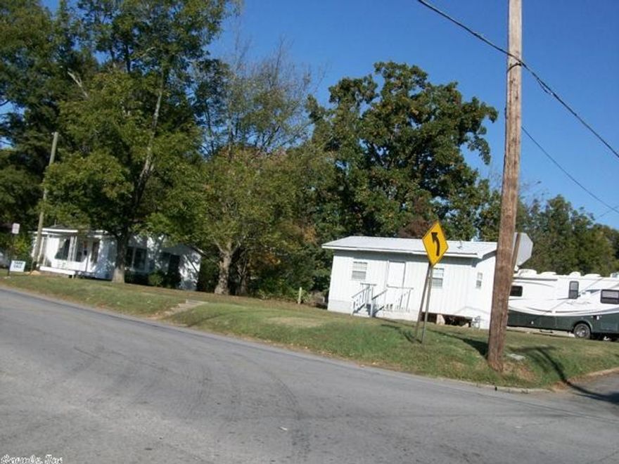 Older house sitting on large corner lot with detached beauty shop