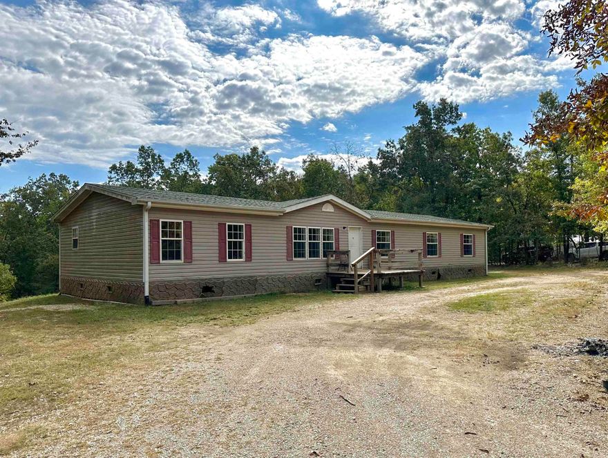 Large Double Wide on 5 acres in Highland! This 4 bedroom, 2.5 bath home features a large open living room/kitchen area, spacious bedrooms, and a large bonus room/game room. The property is all wooded with a circle drive and a storage building that will convey.  New Roof 1 year ago!  Home is being sold as is.  Call for more details!