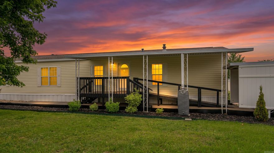 Located in the heart of the Arkansas Ozarks near the Missouri state line, this well-maintained 2011 single-wide home offers comfortable, low-maintenance living in a peaceful 55+ community in Mountain Home, Arkansas. Near Bull Shoals Lake, Lake Norfork, and the Buffalo National River, the property is perfect for enjoying fishing, boating, and outdoor recreation.  The 16x80 home features sheetrock walls and ceilings, giving it a more residential feel throughout the spacious 2-bedroom, 2-bath layout. The kitchen includes granite countertops and a decorative rock accent wall, while the primary suite offers a private bath with a garden soaking tub. Central heat and air provide year-round comfort, and updates include newer windows and a roof replaced approximately two years ago.  Outside features include a covered front deck, back deck, handicap-accessible design, attached 2-car carport, concrete parking pad, and a 10x15 storage shed. Residents also enjoy access to a stocked community lake. Property is subject to a monthly lot fee.
