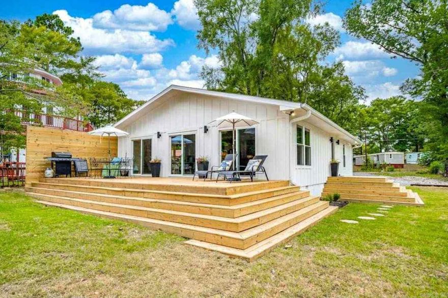 Charming lakefront property offering peaceful views and updated design. Features include a spacious deck, patio seating, and a modern kitchen with quality finishes. The inviting living area offers both comfort and functionality. Located just minutes from dining, shopping, and attractions while benefiting from a quiet residential setting. Thoughtful updates throughout and a welcoming layout make this an excellent choice for full-time residence or investment. Currently used as a vacation rental.