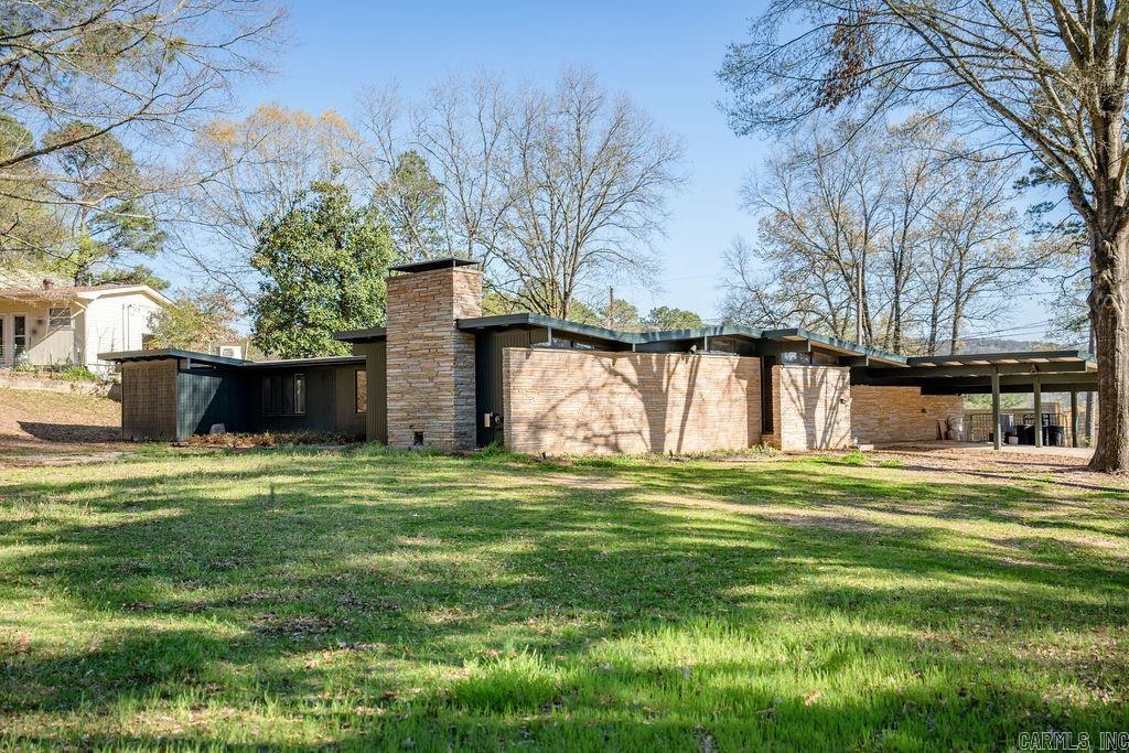 Charming, mid-century modern home on a private corner lot (4 lots to be exact!) in Heber Springs, Arkansas, featuring 4-bedrooms and 4-full bathrooms. This fun, funky home offers multiple living areas, great period furnishings, and TVs throughout. Some recent updates include: New 50-year roof installed in 2023, wood floors were redone, sunken bath redone, concrete was polished and stained, new paint inside and out, mew mini-split installed, new sprinkler system, improved drainage, updated wiring to landscaping lights and added new lighting, new kitchen cabinet doors and hardware, switches and outlets replaced and new appliances! Enjoy a spacious outdoor oasis with an AstroTurf lawn, swimming pool, and expansive decks. The property also includes a 2-car portico and tons of parking. Nearly fully furnished, making it move-in ready! Perfect for entertaining or relaxed Greers Ferry Lake Area living!