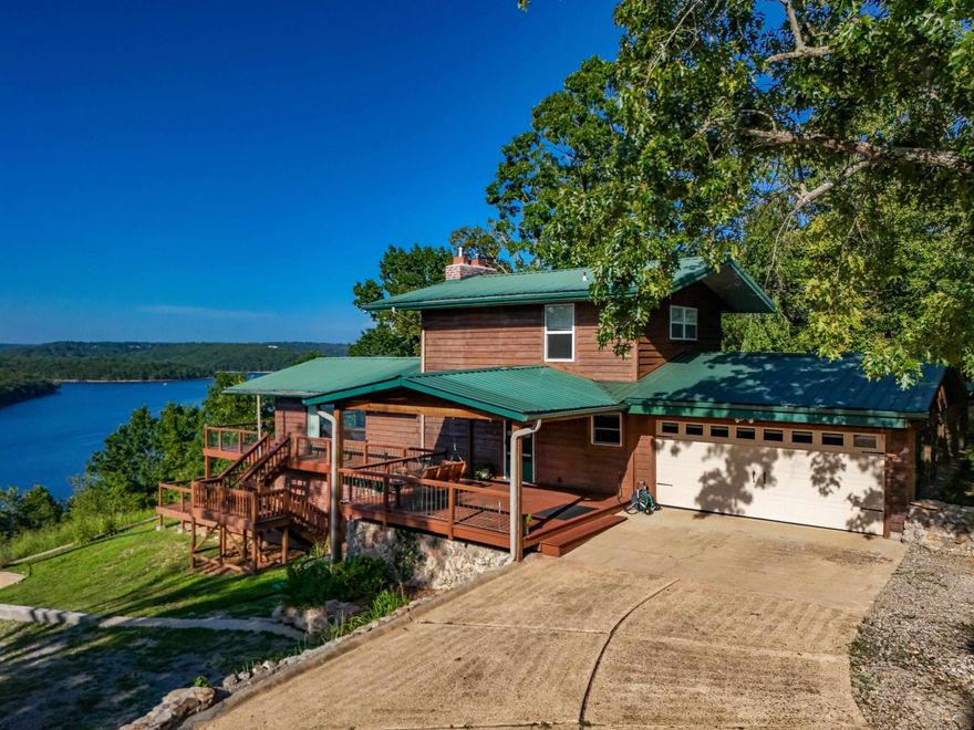 ONE OF THE BEST LAKE VIEWS IN THE COUNTY! Take a look at this 3 bedroom, 3-bathroom home with views of the famous Bull Shoals Lake! This home is clean neat and ready for you to move in! Amazing views from both decks and from inside the home. Basement has its own private bedroom and bathroom. Dual sided fireplace in living room/dining room. Home has had several updates and has a metal roof! If you love to relax, then you have hit the jackpot with this home! Plenty of wildlife, fresh air and peace and quite is what you will find from this front porch!  Close to White River Access and Bull Shoals Lake access!