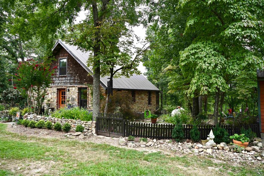 Welcome to your own slice of paradise! Nestled on 5 breathtaking acres, this charming 3 bed 2 bath home is a nature lovers dream.This property features a new metal roof with radiant barrier decking, screened in back porch, custom closet shelving, on demand hot water heater and even has a root cellar. Enjoy the serene duck/koi pond, lush established garden with a variety of fruit trees, barn has water and electricity and a tack room. Don’t miss out on this rare gem with a 3 car detached garage, a detached office/craft building with heat & air, and a Generac generator for peace of mind. This property has everything you need even the shed and hen house have electricity.