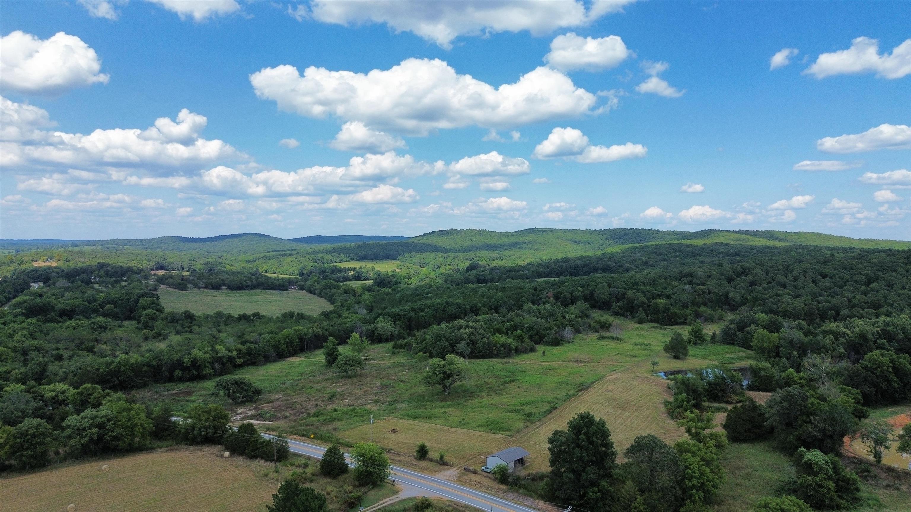 Ozark Mountain land for sale! check out this appr 75 acre Sharp County beauty! A 10 minute drive outside thriving Ash Flat in the highly sought after area of the Old Center Community! A Gated entrance off a paved road starts you out, rural water, electric, NEXT internet, a septic used for a camper is already in place with a carport, that has an enclosed storage. The front area is already cleared, ready for an amazing homesite providing a gorgeous vista view of the surrounding hills bordering the Schales Branch creek offering crystal waters the Ozarks are so very famous for! A nice size pond for fishing or admiring is on the way up to the wooded area for hunting," with plenty of wildlife", hiking, trail riding area of the property that also has several more vista view homesites if you so desire! or for future build projects!!! This has long been a desirable area of our gorgeous community, like going back in times past, yet the conveniences you have grown accustomed to! Not far, BUT far enough from the path of progress! Call Today!!!
