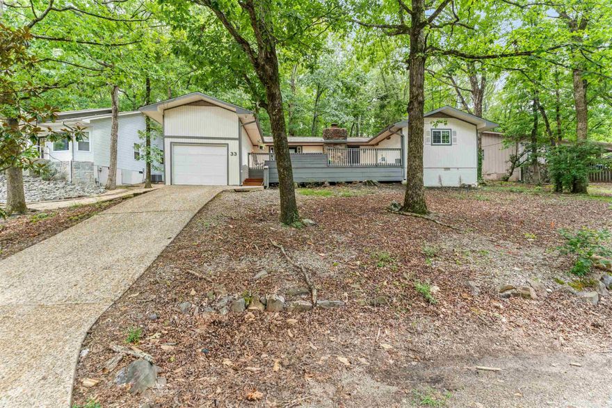 With a view of Lake Desoto, start living the HSV lifestyle! Enjoy vaulted, beamed ceilings, and smart floor plan on one level. The expansive front deck invites you to take in the serene surroundings and view of the lake, while the private back deck is perfect for quiet moments or morning coffee. Blending modern design and everyday comfort, this home offers seasonal lake views and a welcoming, open-concept layout ideal for relaxing and entertaining.   The primary retreat features a generous en suite bath with dual vanities, custom tile finishes, and walk-in closet. The secondary bathroom is equally refined, highlighted by an upgraded vanity and mosaic tile flooring. Updates include Garden tub 2024, Luxury Vinyl Plank flooring and new dishwasher in 2023, 2022 a new heat pump was installed, 2021 Custom Window Shades in all the bedrooms were added and the Crawl Space was encapsulated. This one is move-in ready—just unpack and start enjoying Hot Springs Village's 11 lakes, 9 golf courses, miles of scenic trails, and a warm, active community that welcomes you home. America’s largest gated community, known for its natural beauty, abundant recreation, and peace of mind.