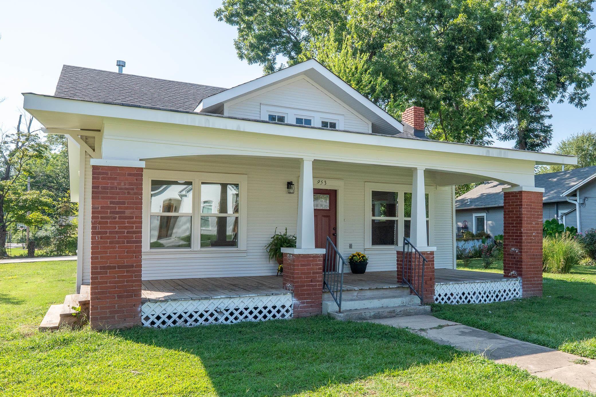 This stunning 3-bedroom, 2.5-bath Downtown Conway craftsman has been beautifully renovated from top to bottom while still highlighting its original charm. Situated on a desirable corner lot, it features a new two-car carport with extra outdoor storage and a spacious yard. The wide front porch welcomes you into the home, where original hardwood floors & original fireplace create a warm and inviting living room. The separate dining area flows into a fully remodeled kitchen complete with stainless steel appliances, farmhouse sink, all wood countertops, center island & abundant storage. All three bedrooms are generously sized with hardwood flooring & updated lighting & the entire home is filled with beautiful natural light. Both full baths have been completely updated with new tile, walk-in showers, and pedestal sinks. A conveniently located half bath & laundry room with a utility sink and storage add everyday functionality. Major updates include new roof, HVAC, windows, appliances & extra insulation providing modern comfort and efficiency in a timeless home. This home blends historic character with modern upgrades, offering a move-in ready opportunity in the heart of Downtown Conway.