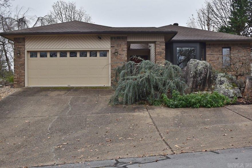 Discover this distinctive home with extraordinary natural surroundings in the heart of HSV, well constructed & ready to be updated to your own taste.  Surrounded by dramatic rocky formations & moss-covered boulders, this solidly built home offers inspiring lake & mountain views from nearly every angle. Welcoming foyer w/a tranquil decorative water feature sets the tone as you enter. Living room opens up with tall volume ceilings & a stunning Mountain View backdrop. Efficient kitchen w/breakfast nook can easily be converted into a gourmet space. Full-length sun deck w/awning expands outdoor enjoyment. Main level features a principle suite w/an artfully designed rock garden, 2 guest brdms, a full bath & a private hot-tub room for relaxation. Lower level expands the home’s versatility w/a spacious media room equipped w/a movie projector & wet bar, ideal for unforgettable entertainment. An additional multi-functional room connects to an A/C enclosed porch, providing year-round usability. Generous storage room w/outside access adds convenience for hobbies. Dedicated mechanical room offers even more storage & a solid safe-room option. $2000 First-time Buy-In fees may apply. Agent Remarks