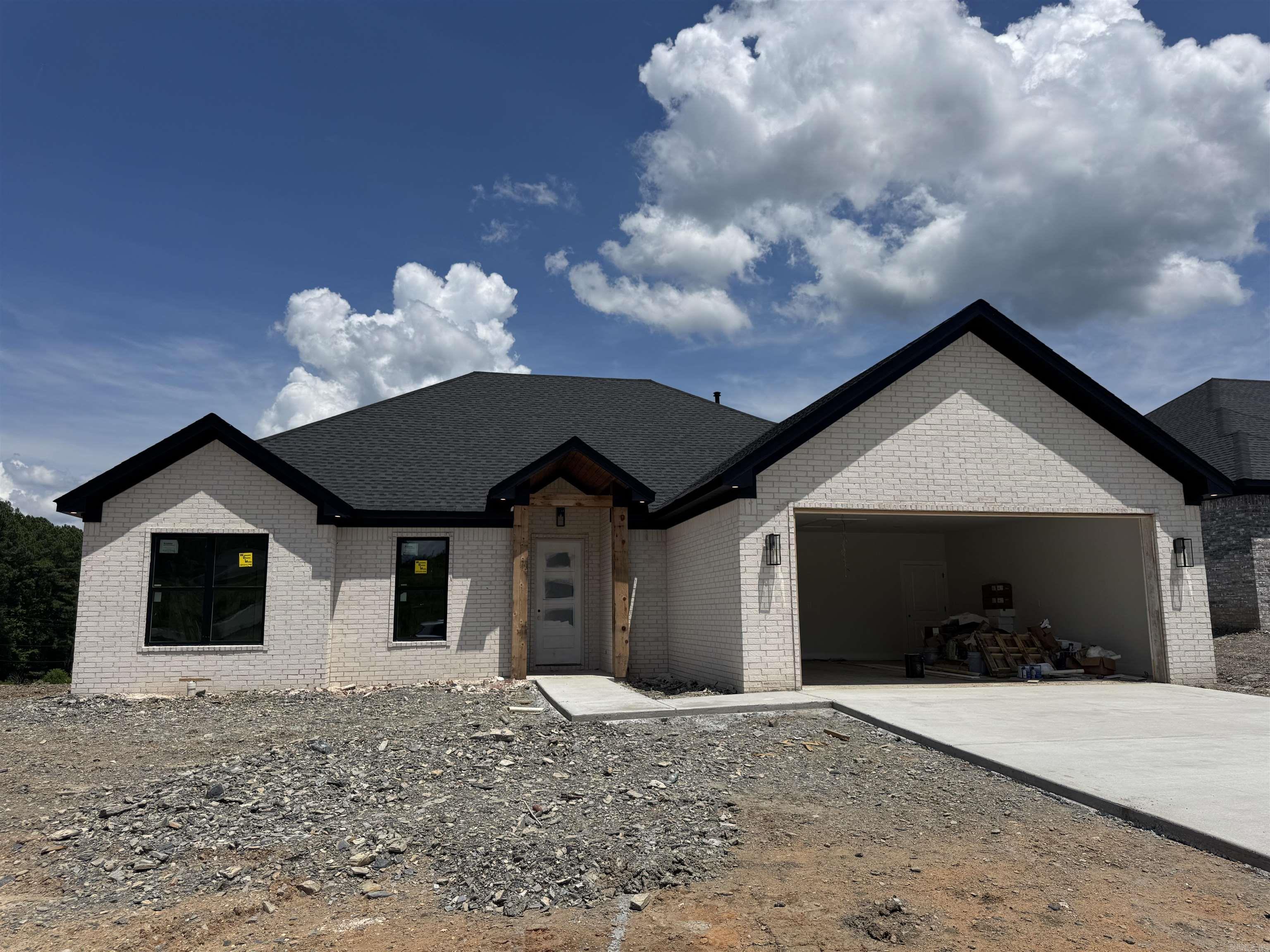 This beautiful new construction home features 4 bedrooms, 2 bathrooms, and stylish custom finishes throughout. Enjoy an open layout with a cozy brick fireplace, a spacious kitchen, and a generous laundry room. The primary suite offers a relaxing retreat with a well-appointed bath and walk-in closet. Situated on a flat lot, the home also includes a covered back patio—perfect for outdoor living.