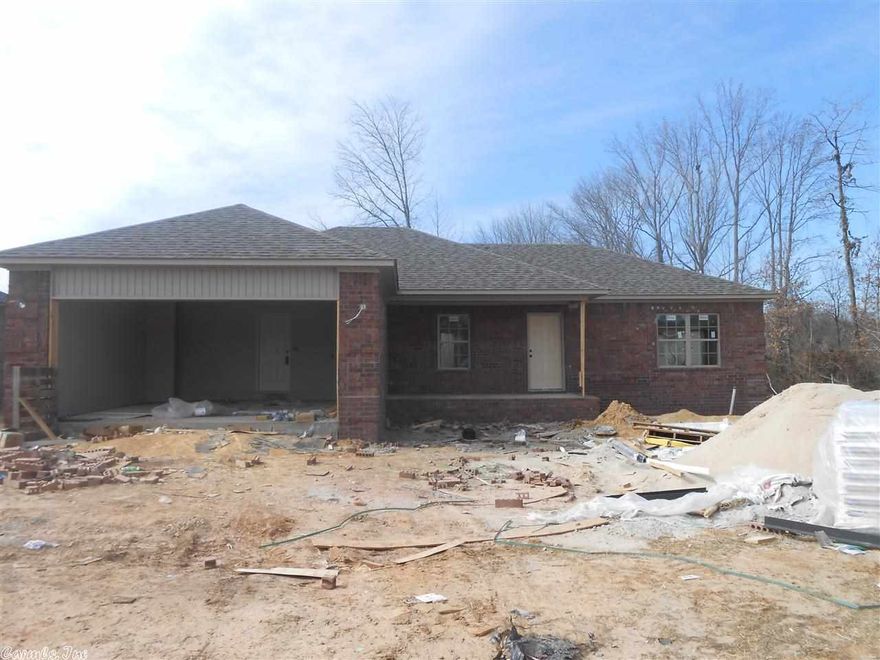 Great new construction in a great neighborhood!  Brick, 4 bedrooms, 2 baths, large living room with wood flooring and pan ceiling,  granite counter tops in kitchen with pretty back splash, stainless steel appliances.   Master bath will have separate shower, Jacuzzi tub, bowl sinks, his and her closets.  Both bathrooms will have granite counter tops, too!  Deck overlooking back yard.  Home has added privacy backing up to woods.   Still time to pick your paint colors!!