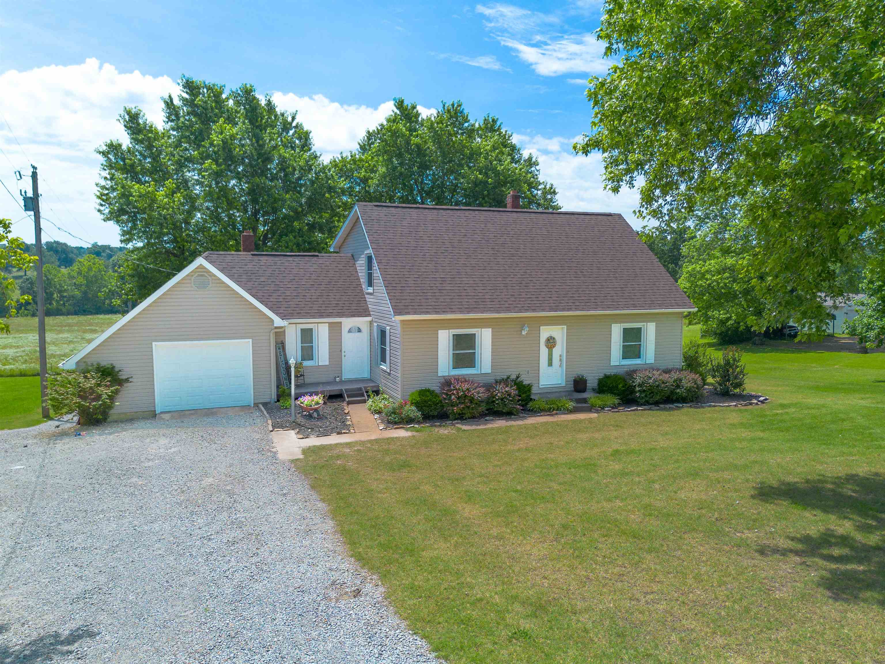 Welcome to this spacious 3-bedroom, 2-bath home at 450 S Main St in Salem, Arkansas. With approximately 2,400 sq. ft. of finished living space, this home offers a large living room, formal dining, an upper level, and a walk-out basement with expansion potential. Enjoy modern comforts with two HVAC units, a wall gas heater, and included appliances. Recent updates like a newer roof/gutters, and hardwood, tile, and carpet flooring add to its appeal. A large one-car garage and ample storage complete the interior. Step outside to a large, shaded lot featuring a basketball court and room for a garden. A spacious wood deck is perfect for entertaining. This home benefits from city water/sewer and low taxes ($997.90 last year). Experience the best of the Ozarks with Lake Norfork, Spring River, and the White River all within a 30-45 minute drive, offering unparalleled fishing, boating, and nature opportunities. Embrace the serene Ozarks lifestyle!