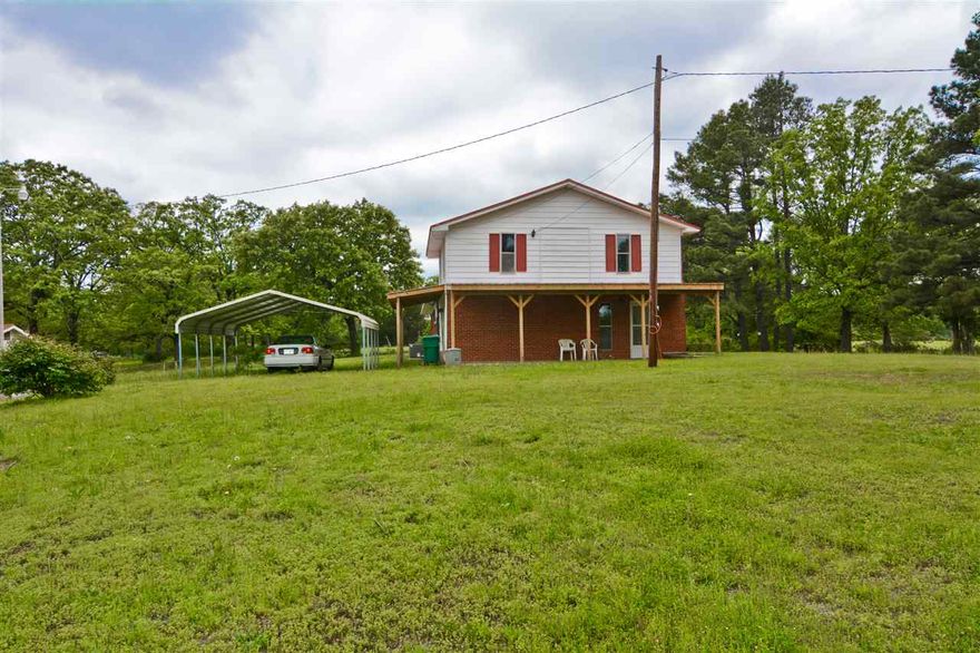 Horse country, nearly 5 acres of rolling pasture,  with pond and well for stock.  Spacious with rustic charm.  New Heat and Air, Upgraded electrical, nearly new metal roof, new counter tops, and carpeting, covered patio, kitchen appliances, House is on public water.  Backs up to Camp Robinson at the end of the Lane. Also has storm shelter