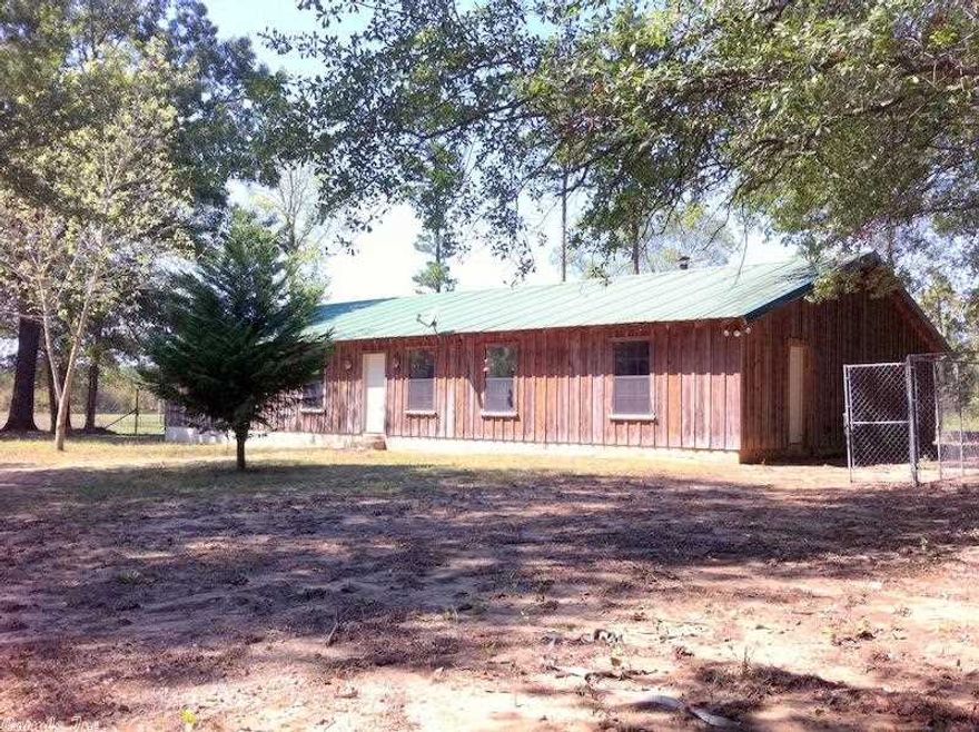 Rustic Home has five bedrooms & 3 baths. Vaulted ceiling and flagstone floor in family room. Master bedroom has outside entry and is separate from the other four bedrooms.  Master bath has jetted tub plus walk-in shower. Mudroom with outside entry.  Barn has horse stalls, foaling stall, tack room with feed bins and saddle racks.  Wood heater sits on a river rock hearth. If you love horses and country living this is the place for you. See showing remarks for gate code.