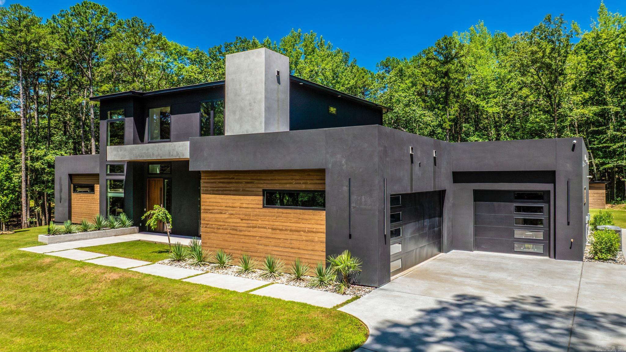 Stunning 2024 custom-built modern home, nestled on 6.92 acres one minute past Chenal Elementary. Perfectly situated near Wildwood Park for the Arts, shopping, and dining, this home offers the ideal balance of seclusion and convenience. Every inch of this property has been meticulously designed with a seamless blend of beauty and functionality. The open floorplan is highlighted by soaring two-story ceilings & a striking center spine staircase, setting the tone for the entire home. The kitchen, dining room, & great room effortlessly flow together, with floor-to-ceiling windows that bathe the space in natural lightācreating a welcoming atmosphere for gatherings. The living area includes a Venetian plaster fireplace. The powder room features Versace wallpaper. On the main level, the primary bedroom offers a spa-like bathroom & an oversized walk-in closet. A private guest suite with a full bath. The office currently serves as a nursery. Upstairs, two additional spacious bedrooms & a beautifully designed hall bath. The covered outdoor patio spaces offer idyllic private wooded views that surround the property. RV parking pad. Quality craftsmanship throughout. Luxury at its best!