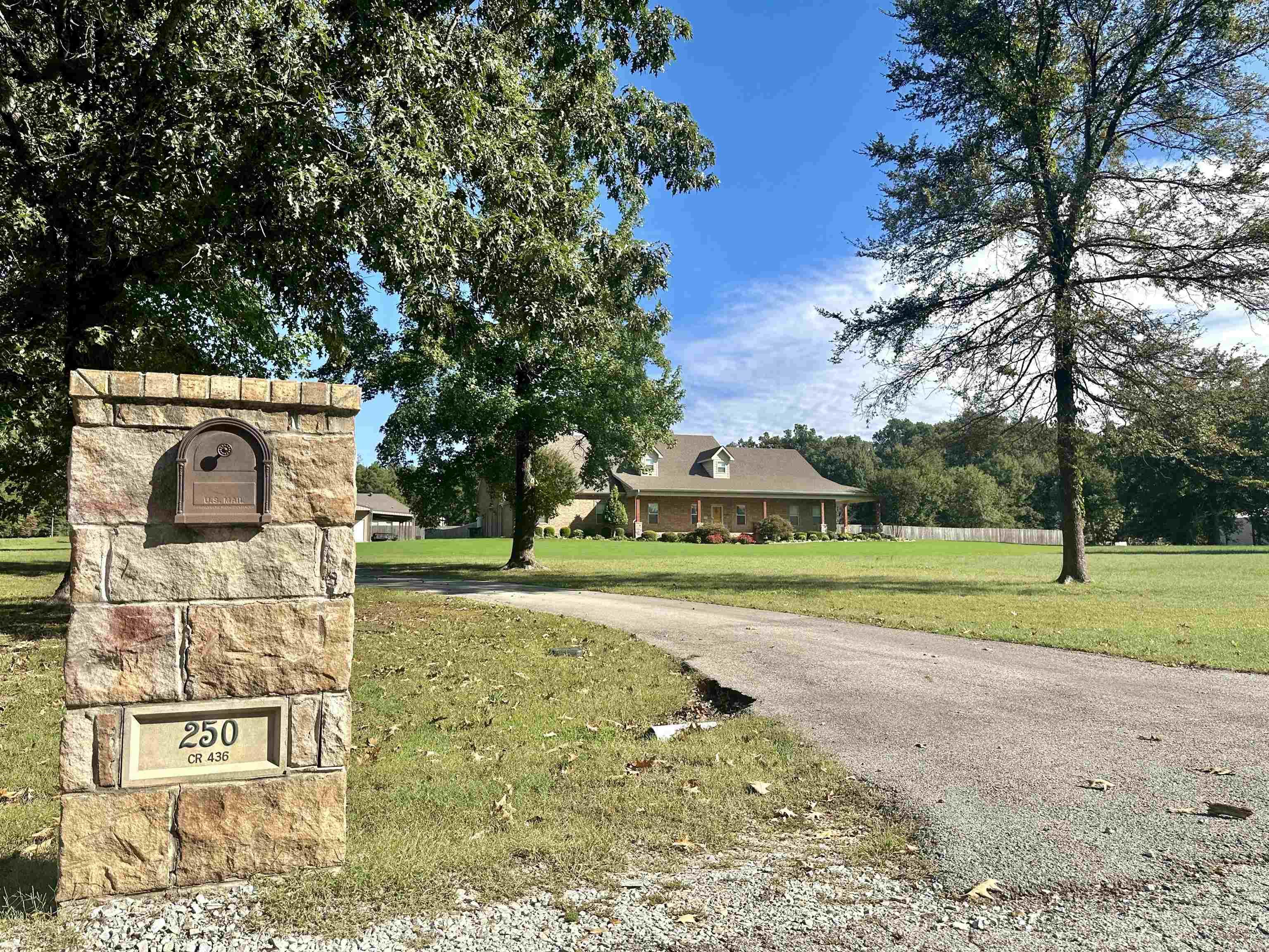 Do you like to sit back, relax and unwind when you come home? This home looks like it was custom built with comfortable, and county living in mind. The wrap around porch also adds to the take a load off feeling.'' Sitting on 3.47 acres, this home gives you lots of breathing room to spread out, tinker in the 30 x 40 ft shop or read the afternoon away in the she-shed. Despite the large square footage,the spaces feel homey. Several family living rooms and/or great entertaining spots make Thanksgiving, Christmas or a summer get together easy. There's an upstairs bonus room, a living, dining area right off the kitchen, and a glassed in, heated and cooled porch with a cozy fireplace that overlooks the fenced in huge back yard. Four bedrooms, 4 1/2 baths give you plenty of room for guests or family members. Two downstair bedrooms have attached baths. If teens are included, the upstairs bonus room can be a great 4th bedroom or hang out spot. It has a huge closet and its own bath. If you work from home, there is a spacious office complete with built ins. There is also tons or storage!