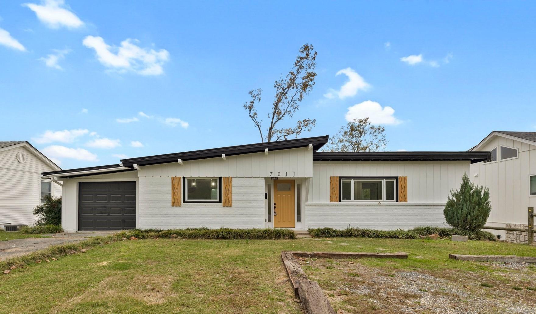Welcome to 7011 Hillwood Road, a beautifully renovated 3-bedroom, 2-bathroom home in the heart of Little Rock. Built in the 1950s, this home perfectly blends mid-century charm with modern updates. On the entry level, you'll find two bedrooms and a full bathroom, offering ample natural light and comfortable living spaces. Downstairs you have 1 bedroom, another full bathroom, and a den with a sleek electric fireplace, perfect for relaxing or entertaining. The kitchen is updated with stainless steel appliances, bringing a modern touch to this classic home. This home is conveniently located near local amenities and offers the perfect mix of style and functionality. AGENTS - See remarks.