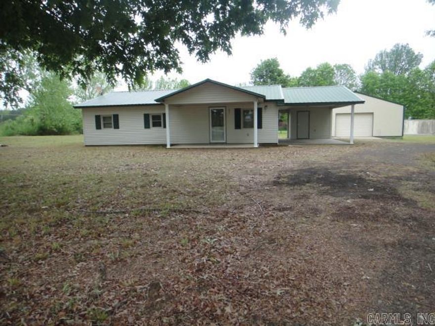 This Cozy home sits on a little over 10 beautiful acres.  The kitchen and living room is an open concept. 3 nice size bedroom with 1 bedroom having a separate entry into the existing bathroom. There is a 30 x 40 concrete slab Shop and another storage building behind it. The acreage is level with large beautiful trees. There is an old homestead lot (.75ac) with its own entrance off Hwy 13 to the West of the house and this lot has all utilities including septic system.  See agent remarks