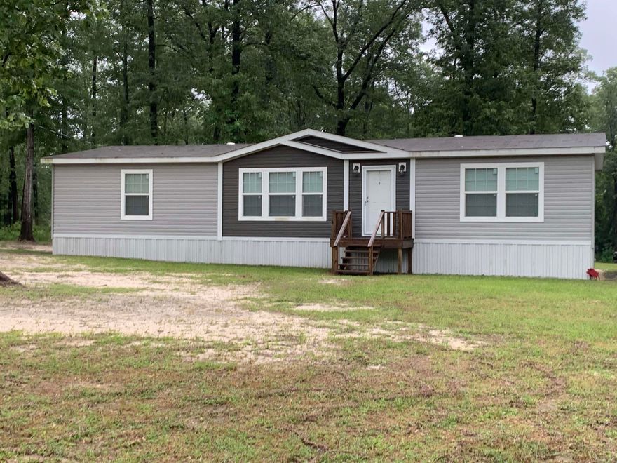 Country living at its best, this 2016 Double-Wide Mobile home is permanently affixed to the peaceful 10.28 acres.  Beautiful views and mature trees.  Three Bedrooms and 2 baths with open floor plan living, dining and kitchen area.
