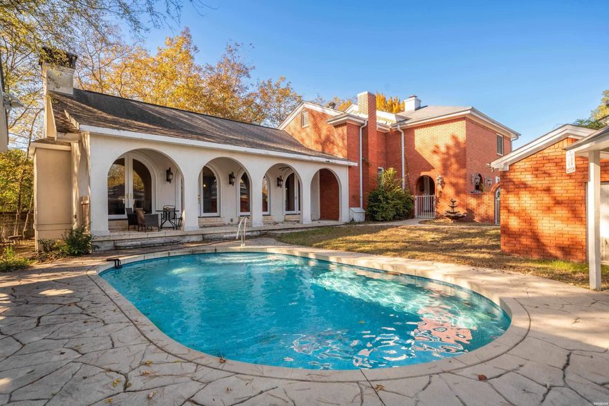 Just a short walk from Oaklawn Racing & Casino, this 4-bedroom, 3.5-bath home offers a flexible layout and strong rental potential. The main level includes two living areas and two full kitchens, allowing for private guest space or multi-use living. A standout feature of the property is the expansive poolside addition. Designed for large gatherings, it showcases soaring ceilings, a full kitchen, and a half bath—all overlooking the heated swimming pool. This space functions as an indoor/outdoor entertaining hub, event space or separate guest area. Situated on a large lot with ample outdoor seating, the home also conveys a transferable short-term rental permit, giving buyers immediate income capability. Ideal for those seeking a spacious primary residence, second home near Oaklawn, or investment property with exceptional entertainment amenities.