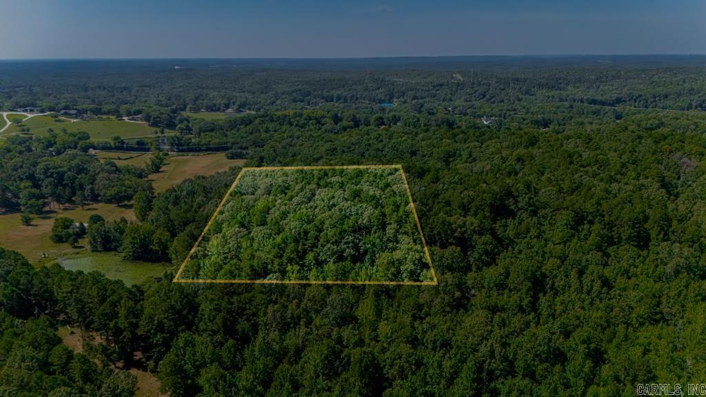 Private 9.91 Acres with Utilities Nearby ā Nearly 10 wooded acres (9.91) offering rare privacy just minutes from I-40 and amenities. Outside city limits with residential zoning. Road easement in place, electric available. Ideal for a private estate or investment hold. No HOA. Quiet, wooded setting in a rapidly developing areaāperfect for those seeking space, seclusion, and opportunity.