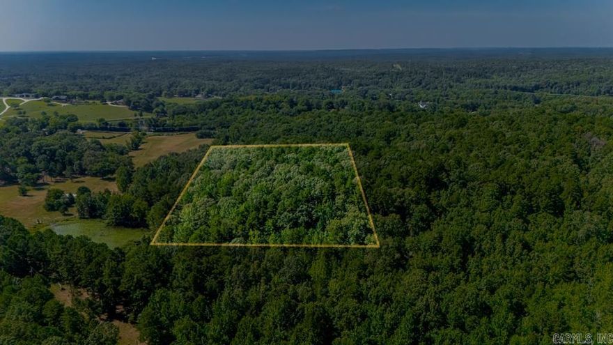 Private 9.91 Acres with Utilities Nearby – Nearly 10 wooded acres (9.91) offering rare privacy just minutes from I-40 and amenities. Outside city limits with residential zoning. Road easement in place, electric available. Ideal for a private estate or investment hold. No HOA. Quiet, wooded setting in a rapidly developing area—perfect for those seeking space, seclusion, and opportunity.
