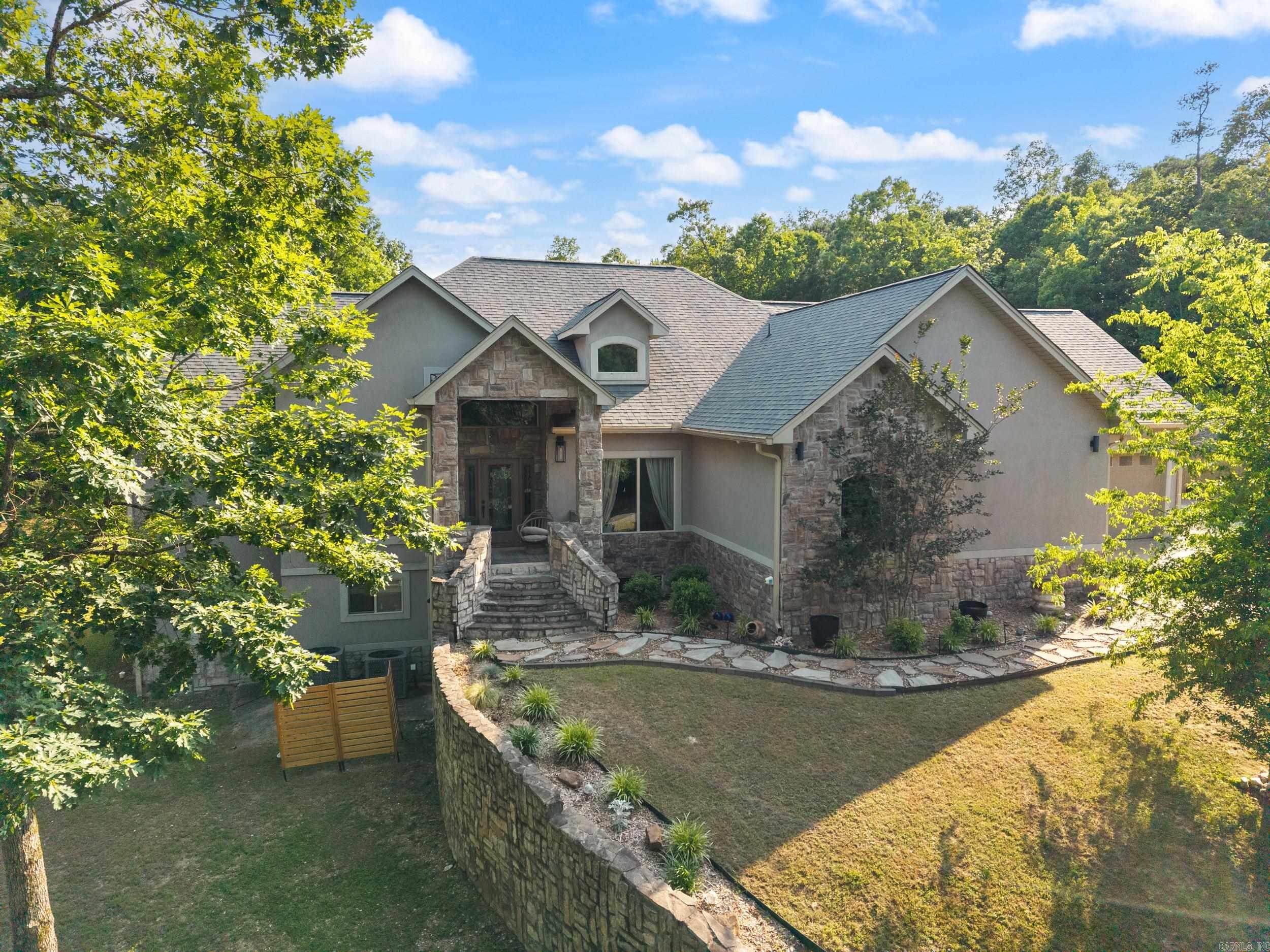 Set on 5.38 acres just outside the city limits, this custom home combines luxury, space, and privacy. With over 5,500 sq. ft., it features 6 bedrooms, 5.5 baths, and a spacious living room with soaring ceilings and a cozy fireplace. The versatile in-law suite or second living area adds extra convenience, while two remodeled kitchens with stainless steel appliances make cooking and entertaining a breeze. Additional highlights include two laundry rooms, a formal dining room, a bonus room, and an office that can double as a bedroom. The newly remodeled master bath offers a spa-like retreat. Recent updates include a new roof (4 years old) and dual central heat and air systems, ensuring year-round comfort. Three fireplaces and a 3-car garage complete the home, which sits on 5+ expansive acres, perfect for outdoor living, gardening, fun or future development. Just minutes from city amenities, this property offers the ideal blend of luxury living and rural tranquility.