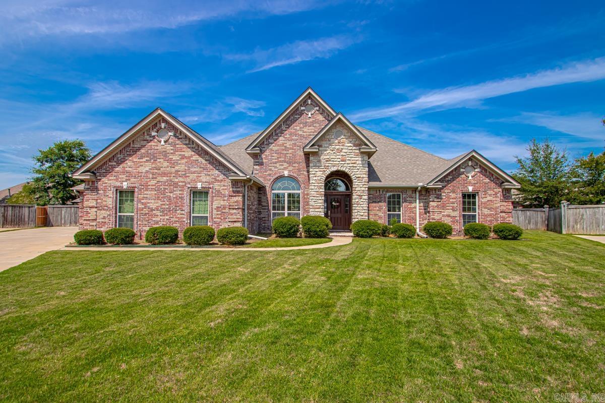 Beautiful one-story home in Country Club of Arkansas! 4 bedrooms, 2.5 baths with a split bedroom floorplan. Plenty of windows for great natural light. Spacious living room with double-sided fireplace that opens into a large sunroom that offers flexible additional living and dining space with room for both. Kitchen features Caesarstone countertops and stained cabinets. There is a separate office, large mudroom, tankless water heater, fully fenced level lot with storage shed, and a 3-car garage with 3rd bay extra deep, plus a pull-through door to the backyard. Roof replaced in 2022.