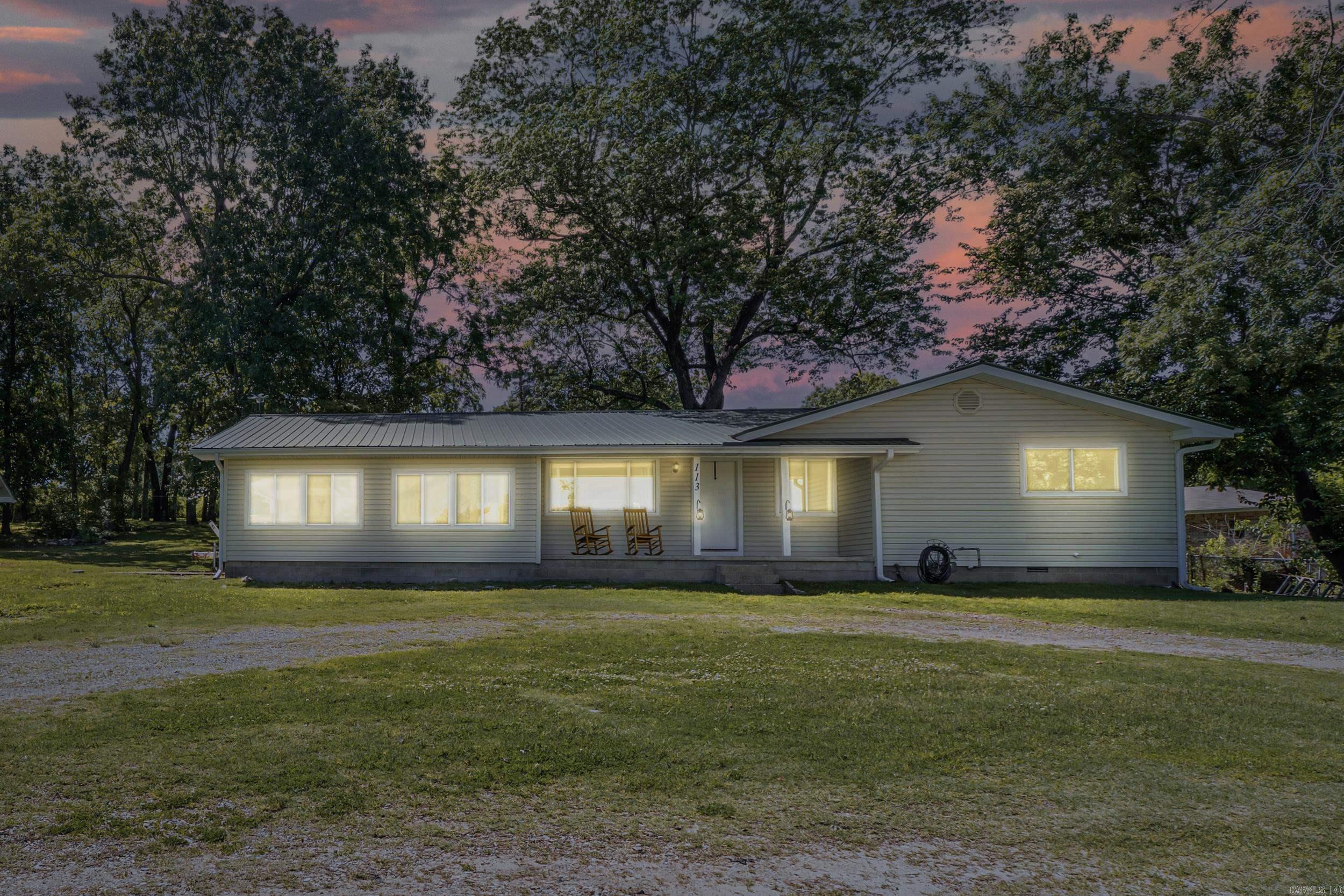 On the edge of town and right across the street from a brand-new water park, this one-of-a-kind property offers comfort, flexibility, and room to expand. The 3-bedroom, 2-bathroom main home features a tastefully upgraded kitchen with granite countertops, real wood cabinets, and a spacious pantry. You'll love the warmth of the wood floors, the charm of a natural gas fireplace, and the convenience of a large laundry room, metal roof, attached garage, and whole-home generator. Set on a 0.72-acre m/l end lot with mature shade trees, the property also includes an unfinished guest house or shop with its own dedicated well. And main home on a separate well. With no restrictions, two wells, and two separate structures, this property is ideal for extended family living, a rental or Airbnb opportunity, or a home business. The location adds even more value—enjoy peace and privacy with the fun and convenience of the new water park just steps away.