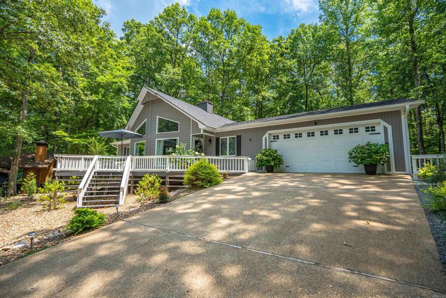 This awesome home sits up and across the street from Lake Cortez with amazing winter views.  The front deck is made for enjoying the view and the furniture on the deck conveys!  So many improvements have been made to make this an inviting place to live.  OUTSIDE: 2024 new Roof & Gutter Leaf guards, freshly painted, new water faucets & newer front deck railing, recently swept/clean chimney. Back patio fence has solar lighting, for getting cozy at night and looking at nature with all the trees. Newer insulation was added in the attic.   INSIDE: features new paint, vaulted ceilings, a gas fireplace, new stove (2 months ago), beautiful countertops that can handle heat & easy to clean.  (w/no cuts or seams). Newer Luxury Vinyl floors throughout, and custom draperies on various windows. The sunroom was enclosed and now added to sq ft. Add a sleeper sofa in the sunroom for extra sleeping when family/guests visit.  Call or text listing agents to see this move-in GEM today!  Agents See Remarks.