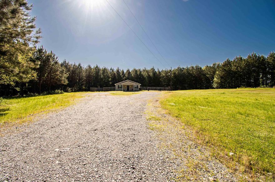 "Discover your own private haven on 2 sprawling acres in the countryside. This charming starter home boasts 2 bedrooms, 2 bathrooms, and 1200 square feet of cozy living space. Surrounded by lush greenery, it offers ample privacy for serene living. Ideal for those seeking a quiet escape or a cozy retreat from the hustle and bustle of city life."