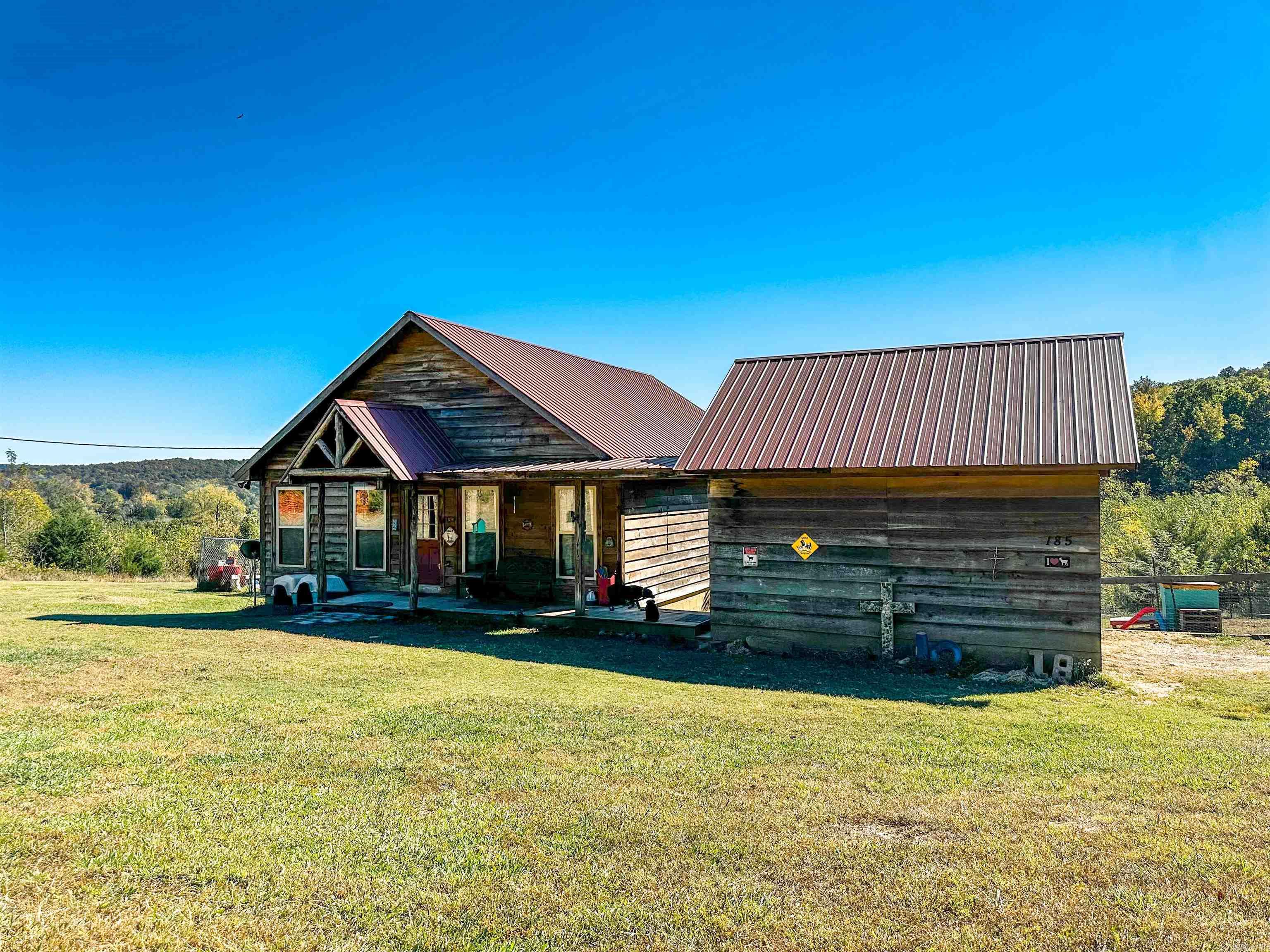 No. 25008: Welcome to your homesteaderās dream! This charming 2-bedroom, 2-bath cabin offers 1,280 sq. ft. of cozy comfort on 2.04 beautiful acres. Enjoy peaceful sunrises and sunsets from both the front and back porches while watching wildlife roam the property. Inside, red cedar ceilings, a loft, and a cozy fireplace create the perfect rustic retreat. The kitchen features live-edged countertops and a spacious walk-in pantry. The master bedroom includes a seated shower, while the second bedroom offers a generous walk-in closet and bathroom access from the bedroom. Laminate floors flow throughout, and additional storage closets provide plenty of space to stay organized. Outside, youāll find a fully fenced yard, detached carport with breezeway, separate garage, bays for animals, and a lovely garden area. Whether youāre looking for a peaceful getaway or a place to embrace country living, this property combines comfort, functionality, and natural beauty in perfect harmony. Priced at $229,000