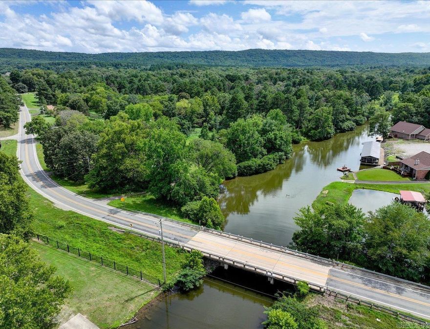 ATTENTION DEVELOPERS - RARE LAKEFRONT OPPORTUNITY! This is one of the last big parcels of land on Lake Hamilton for development. +/-7.76 acres with +/- 1573 feet (est.) of lake frontage in the highly sought after HWY 7 South corridor, with over 350 feet of frontage on HWY 290. This prime property is located in Lakeside School District and all utilities are at the highway. Land is flat with two beautiful inlets surrounded by mature oak and pine trees—creating a serene and picturesque setting for your next development. This is the best parcel of lakefront property in a while. Whether you're envisioning lakefront homes, a resort-style community, or a private retreat, the possibilities are endless. Opportunities like this don’t come around often—schedule a visit and see for yourself why this is one of the best parcels to hit the market in years! There is a mobile home and outbuilding on the property, but the value is in the land and there is one sewer pump for the mobile home.