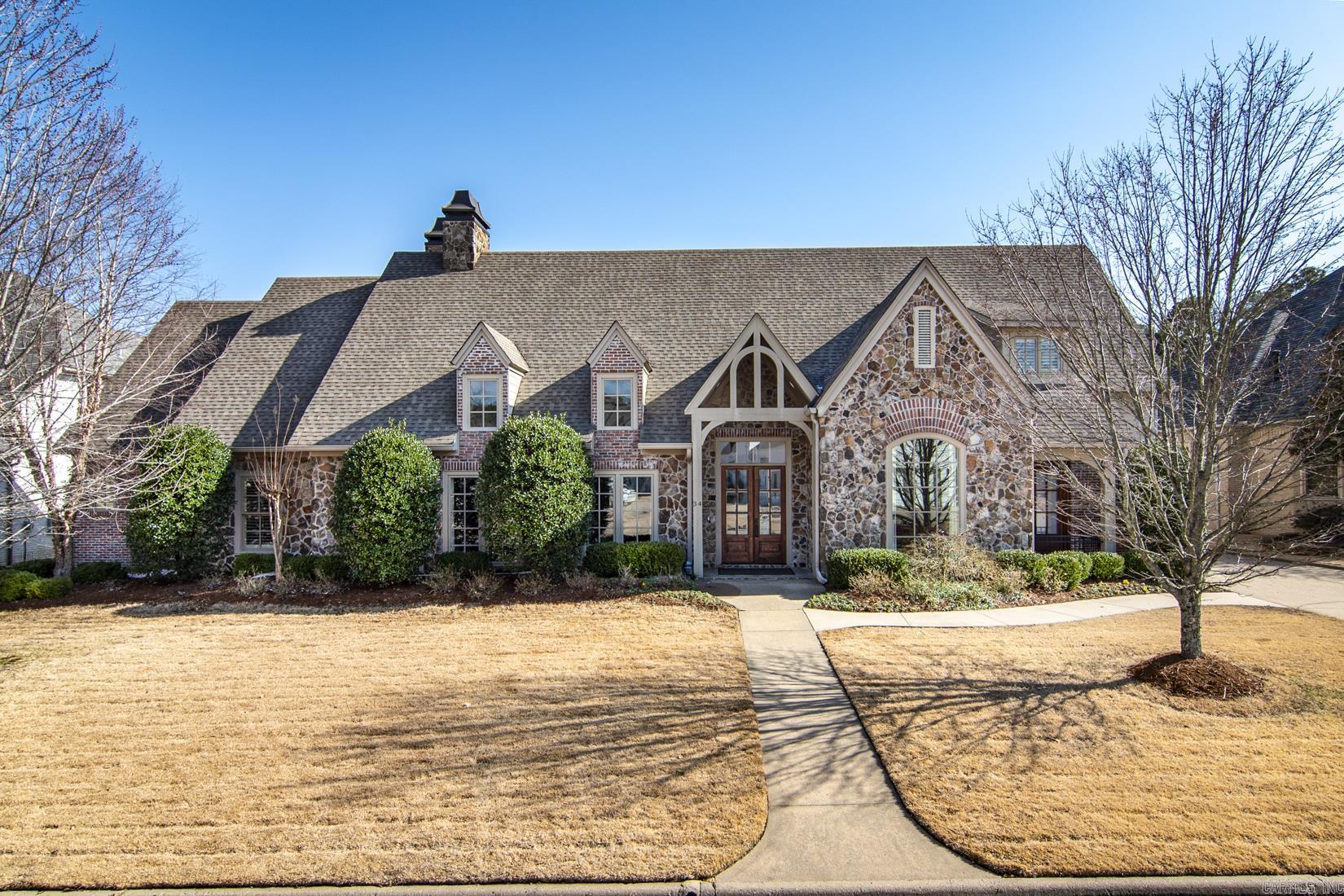 Impeccably maintained executive home in prestigious Chenal Valley gated neighborhood. This home has the finest of finishes with heart of pine and brick floors, vaulted ceilings, beautiful moldings, 8 ft. doors, and slab granite countertops. The open floorplan offers a great place for family living as well as entertaining. The light filled sunroom overlooks the inviting heated and cooled swimming pool and waterfall. There are 4 fireplaces, one woodburning in the sunroom and 3 others..one in primary suite, greatroom and hearth room. The chef's kitchen has top of the line appliances, built-in refrigerator and copper vent over gas cooktop. There is a butler's pantry and walk in pantry easily accessible to the Formal dining room. There are 3 bedrooms on the main level and 2 bedrooms (one could be an office) and fully equipped media room with projection tv and screen upstairs. Additional amenities include a saferoom, 3 tankless HWH, security camera system, whole house generator and much more.