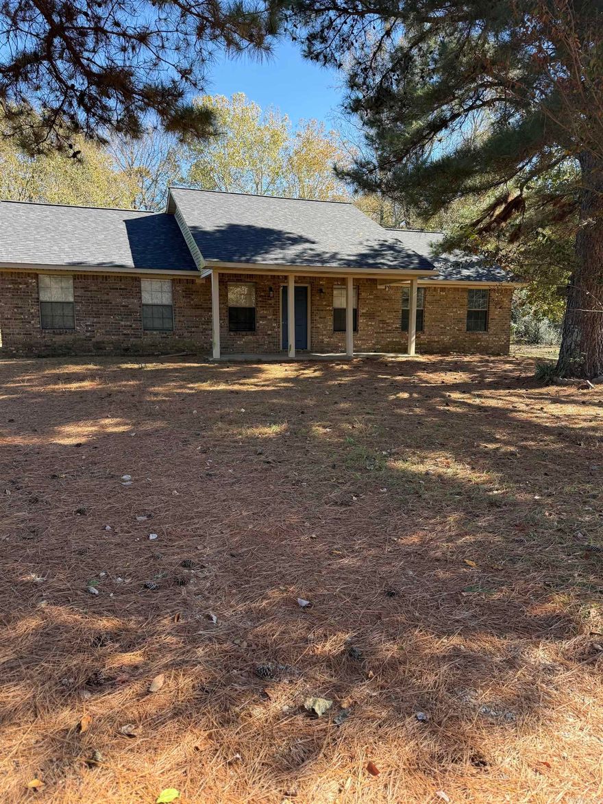 Country living north of town, brick home with 30x40 shop building, 8.39 acres and a pond.  Property offers approx 1,650 sq ft of living space, 3 bedrooms and 2 full baths.  Large living room with gas-log fireplace, spacious kitchen, stove, refrigerator and dishwasher to convey.  Laundry room, attached covered 3-car carport, storage building and extra pad with electricity/well water and septic.  New Roof in 2025, some fresh paint, newer floor coverings, and some new windows in 2025.  Shop building has concrete floors, insulation, large roll up door, electricity and side covered storage/parking.  Property is partially fenced, with road frontage.  Contact our office for more details or to schedule a private viewing.