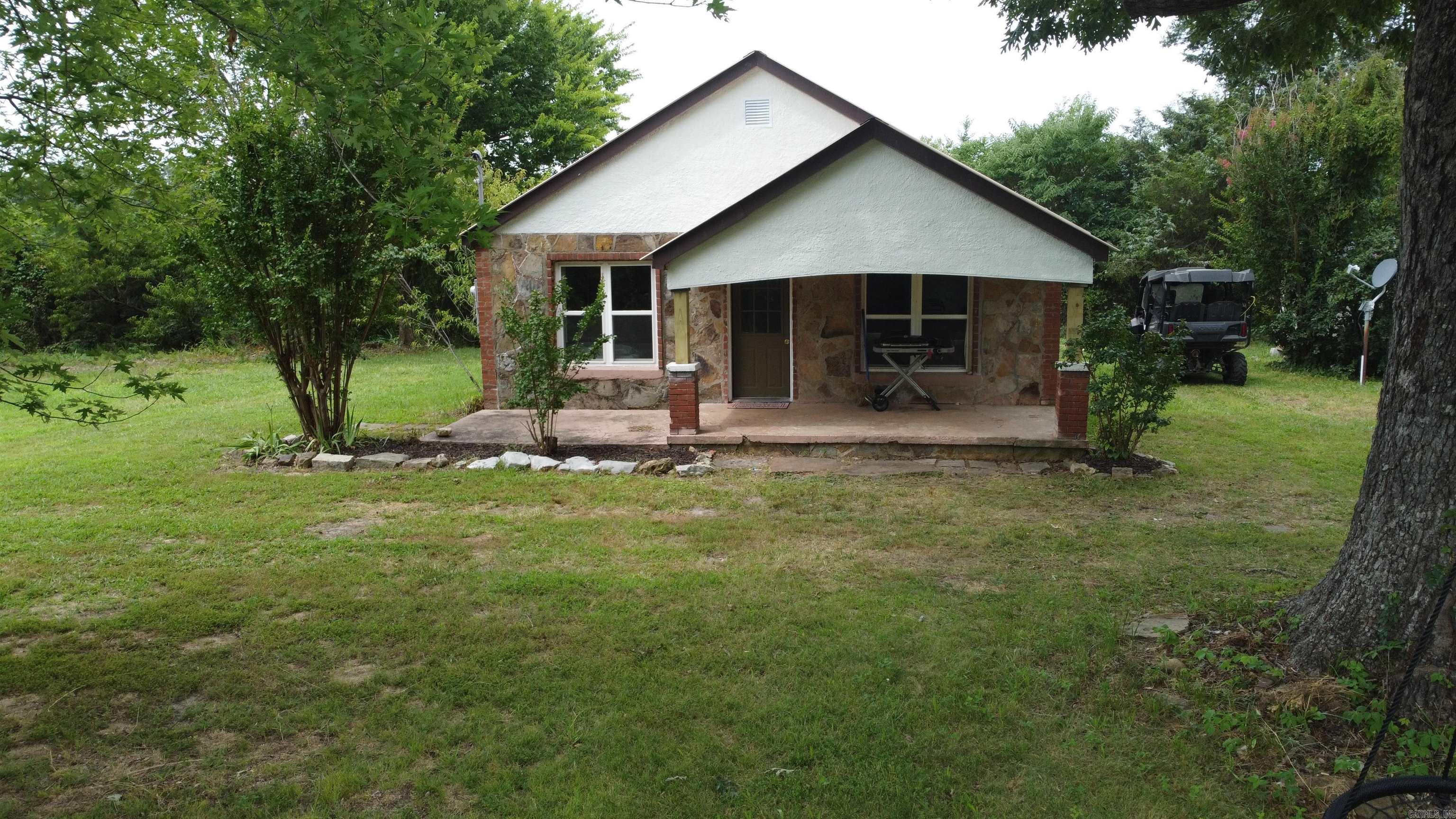 Charming 2 bed, 1 bath home with 975 sq ft of living space, nestled on approximately 1 acre in the heart of the Ozarks. With state highway frontage, access is easy—perfect as a full-time home, weekend getaway, or Airbnb investment. Inside, enjoy a warm blend of hardwood, tile, and carpet flooring. The updated kitchen features granite countertops and modern touches. Fiber internet is available, making it ideal for remote work or streaming. Just 15–20 minutes to the Buffalo National River for fishing, kayaking, canoeing, hiking, and hunting, and numerous other outdoor activities. Only 10 minutes to Marshall for daily needs, shopping, and dining at the locaal resturants. Spend your evenings sitting under the stars or at the nostalgic Kenda Drive-In, one of the last of its kind. Located just 1.5 hours from Branson, offering world-class entertainment, shopping, and attractions. Whether you're looking to relax, explore, or invest, this peaceful Ozarks retreat offers endless possibilities in a scenic, adventure-filled location. Come see the peace, tranquility and beauty of the Ozarks!!!