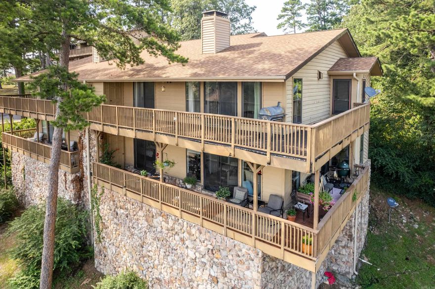 Welcome to this generously sized walk-in level condo featuring 3 bedrooms, 2 full baths, and an attached garage—perfect for easy access and comfortable living. The open-concept living area boasts a cozy stone fireplace, wood beam ceilings, and access to a private balcony with beautiful views.  You’ll love the dedicated bar area, ideal for entertaining guests, and the large kitchen with ample cabinet space and classic wood finishes. While some updates could bring it to modern style, the space and layout offer unlimited potential to create your dream retreat.  Enjoy community amenities including a sparkling pool and hot tub, all set within a serene, wooded environment just minutes from local dining, shopping, and outdoor recreation.  Don’t miss your chance to own one of the largest floorplans in the community—ideal as a primary residence, vacation getaway, or investment opportunity!