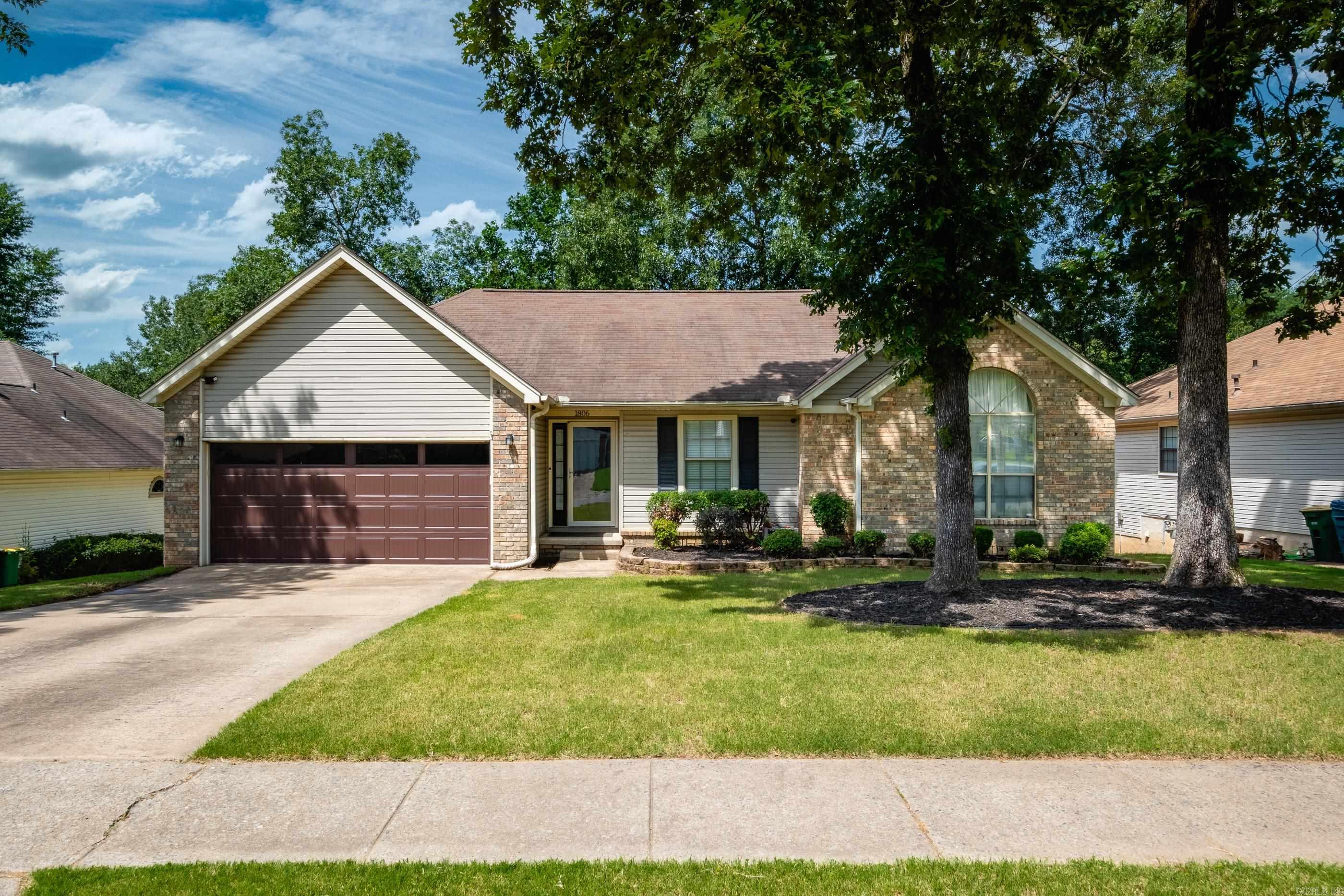 Lovely home with a large, fully fenced backyard and a spacious eat-in kitchen featuring slab granite counters, tile flooring, dining area, new electric range, and new Bosch dishwasher. New Pergo sustainable laminate wood flooring in the living area and bedrooms. The large living room includes a gas starter fireplace and opens to the back deck, perfect for outdoor living. The primary suite includes a custom tile shower, jetted tub, and two closets. One guest bedroom offers a vaulted ceiling, and the second is located across from the hall bath. Two car garage, new hot water heater, and new furnace. Great location close to shopping and dining. Come see.