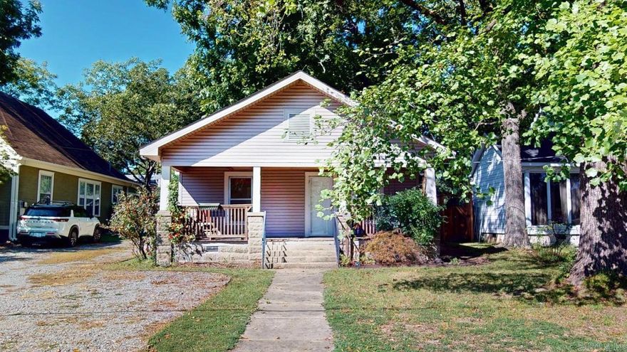 Charming and full of character, this 2 bedroom, 2 bath bungalow blends warmth and style with modern updates. Covered front porch with porch swing offers the perfect set up to spend time relaxing and unwinding. Step inside to find the living room with bamboo flooring & rich wood beam & brick accents that create a welcome and natural feel. The kitchen, which opens into the cozy living room,  is equipped with stainless steel appliances including a gas stove as well as pantry and breakfast bar. Both bedrooms are comfortable and well appointed while the bathrooms feature tasteful finishes. Don't miss the extra bonus room inside one bedroom that could easily be used as an office or convert to a large walk in closet. Outside, enjoy a fully fenced backyard ideal for pets, play or entertaining, along with a large shed that offers plenty of storage or workshop potential. This home combines comfort, functionality, and timeless bungalow charm. All appliances convey including washer/dryer and refrigerator. HVAC units are new and individually controlled per each bedroom & living areas.