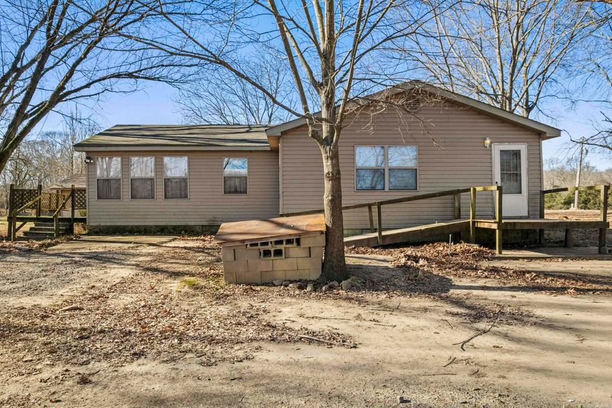 Acreage with creeks, pasture, woods and a 10+ acre pond stocked with various kinds of fish.  Small house exists on this property with several outbuildings, a nice shop and barn. The house is 3 bdrms 1 bathwith a  newer roof, water heater 2014 HVAC original and still work floors seem solid and the house is solid and was home to a family until a couple months ago. The potenital lies in the land.  Seller ran cattle on it and had several other kinds of animals with ample water  supply from the pond and Bull Creek. Location is close to the interstate and would offer a varity of possibilities for development.  Investors and Developers this is worth checking out.