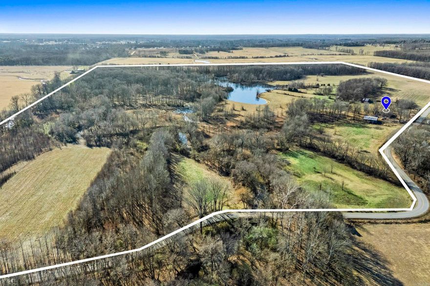 Acreage with creeks, pasture, woods and a 10+ acre pond stocked with various kinds of fish.  Small house exists on this property with several outbuildings, a nice shop and barn. The house is 3 bdrms 1 bathwith a  newer roof, water heater 2014 HVAC original and still work floors seem solid and the house is solid and was home to a family until a couple months ago. The potenital lies in the land.  Seller ran cattle on it and had several other kinds of animals with ample water  supply from the pond and Bull Creek. Location is close to the interstate and would offer a varity of possibilities for development.  Investors and Developers this is worth checking out.