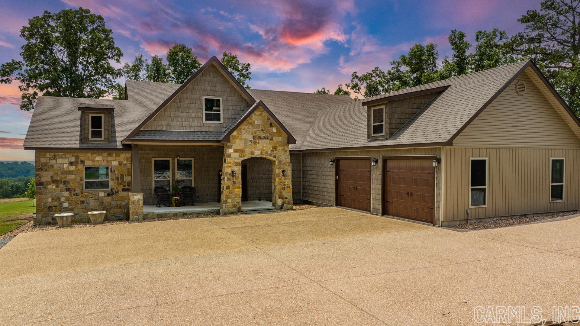 Use 134 Mill Creek for the address to the Open House today! Welcome to 5+ Acres of this breathtaking sanctuary in picturesque Greenbrier. Nestled amidst rolling hills, this residence offers awe-inspiring views and impeccable craftsmanship. The modern home maintains unique charm with hickory floors, 10ft ceilings, and abundant natural light from oversized windows. The kitchen, with high-end granite countertops and ss/appliances, connects to a massive secondary kitchenette and pantry. Beyond the luxurious living spaces, find a wood-burning stove, and a propane generator for security and comfort. The property also includes a dream workshop, heated and cooled for year-round use, a bonus game room, and a unique split bedroom layout. The upstairs acts as a separate house, featuring a 1000sqft mother-in-law suite and an additional 1000sqft that needs final finishing to instantly add to your life and homes equity . This sanctuary home, set in the tranquil Greenbrier hills, is the epitome of Arkansas luxury, designed for refined living. Indulge in the serenity of nature, and the shifting of seasons as you enjoy every sunrise and sunset from your back deck.