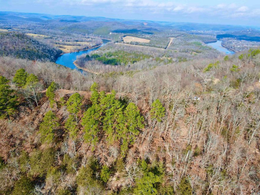 27.57 +/- acres nestled just 10 +/- minutes from the captivating town of Eureka Springs, Arkansas, and this vacant land is a haven of natural wonders. The property unfolds with awe-inspiring views that stretch across the scenic tract, setting the stage for an idyllic retreat. Imbued with geological marvels, including captivating rock outcroppings and shelter bluffs, the landscape is a testament to the Ozark's timeless beauty. A meandering wet-weather creek, natural springs, and a tranquil pond add a harmonious touch, creating an environment that beckons those seeking both serenity and a connection to nature. Immerse yourself in panoramic views that redefine the meaning of breathtaking. Looking to the South you can overlook the property in the valley. From the Northern end of the property, you can sneak a view of the World Class White River. Practicality meets charm as power availability at the county road ensures modern convenience without compromising the rural ambiance. This land is not just an opportunity to build a home; it's an invitation to craft a lifestyle that seamlessly blends with the surrounding splendor. With every amenity at your fingertips and the cultural richness