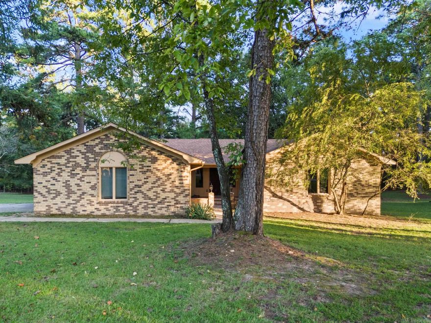 This home sits on a peaceful 1 acre lot surrounded by beautiful mature trees.  Note the custom wood details throughout the home, including cedar closets.  The neighborhood lake is in close walking proximity to the home where residents have access to fishing, kayaking and more.  The park like setting lot boasts a fenced in area and a RV pad with electrical hookup.  Dead end road, no thru traffic.  As you relax on your back deck keep your eyes peeled for the wonderful wildlife.  Country setting but yet close to the cities of Benton, Little Rock and Hot Springs.